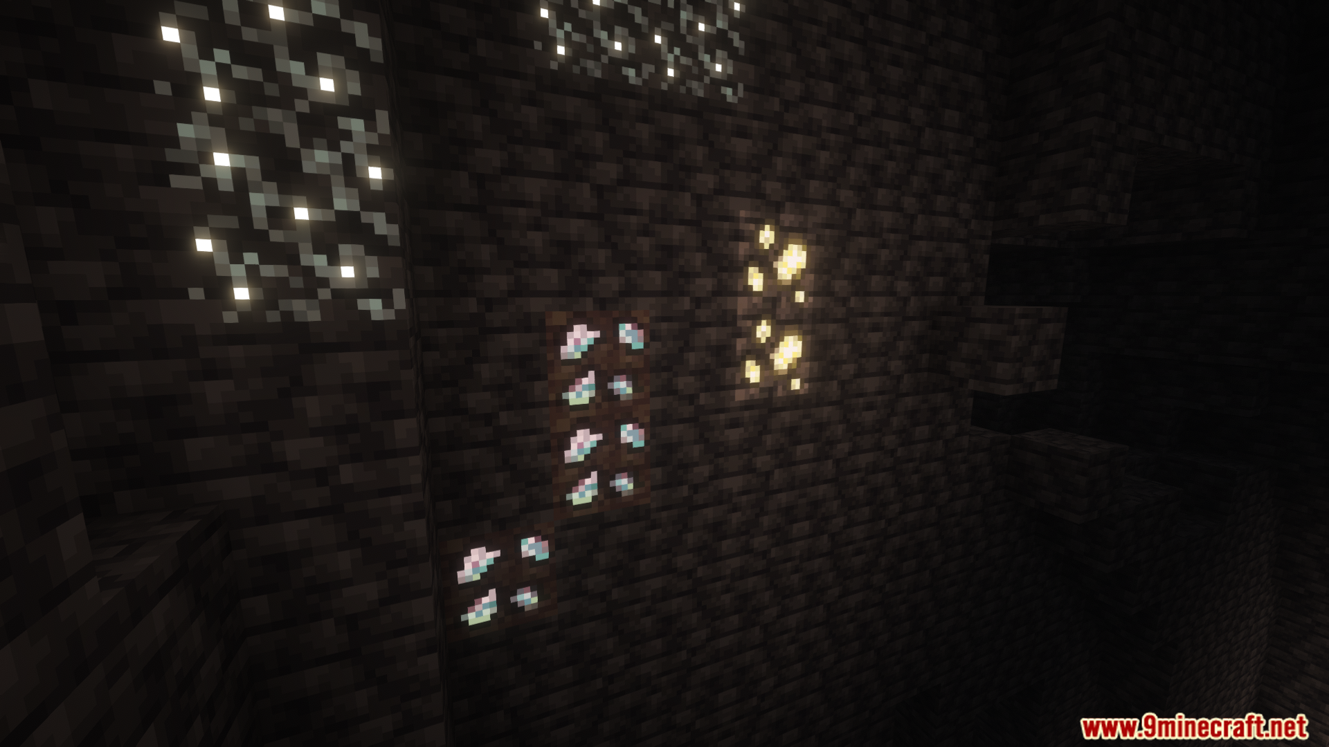 Different types of glowing ore veins on a cave wall