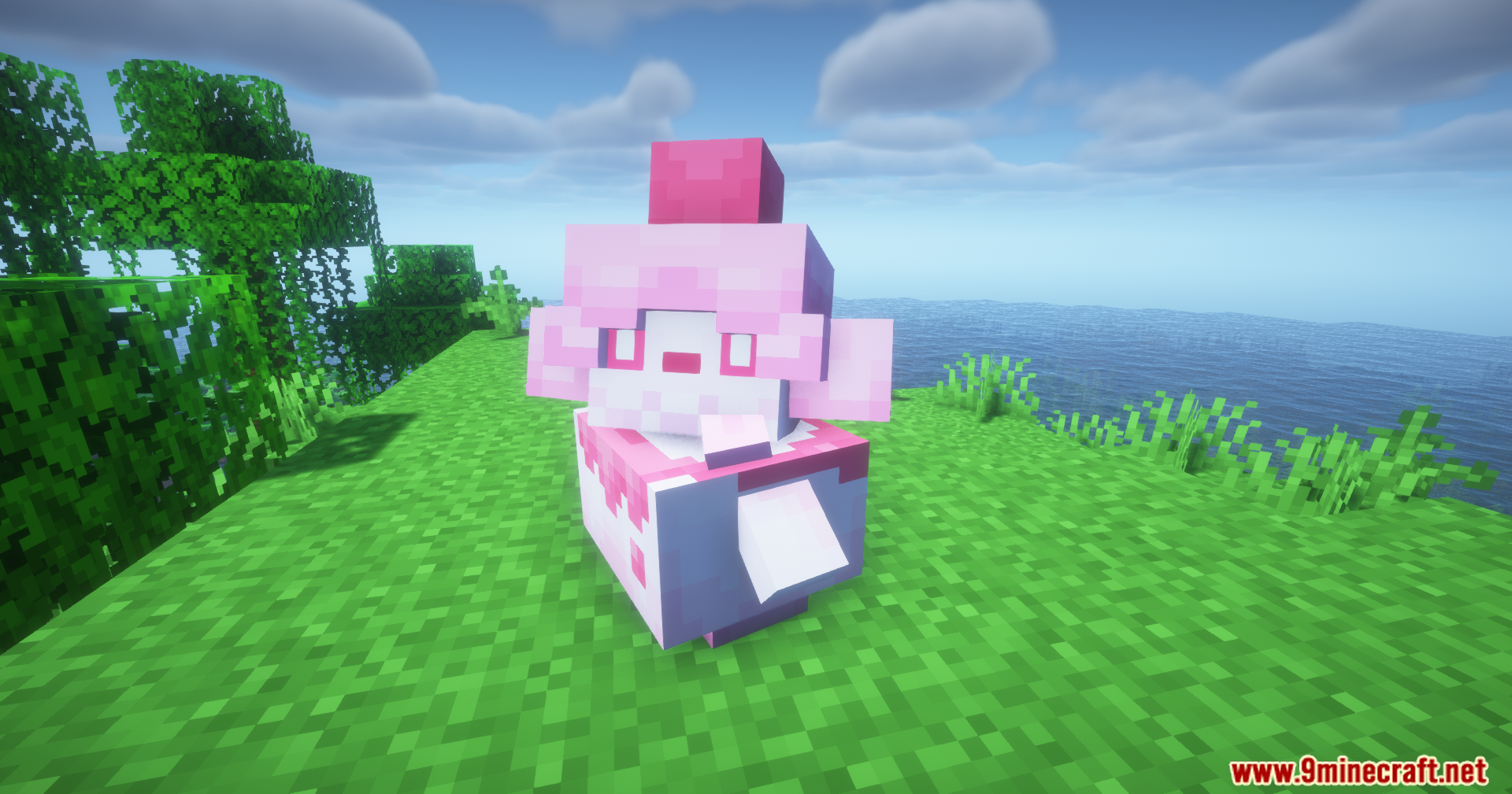A pink and white creature with a cherry on its head standing on grass