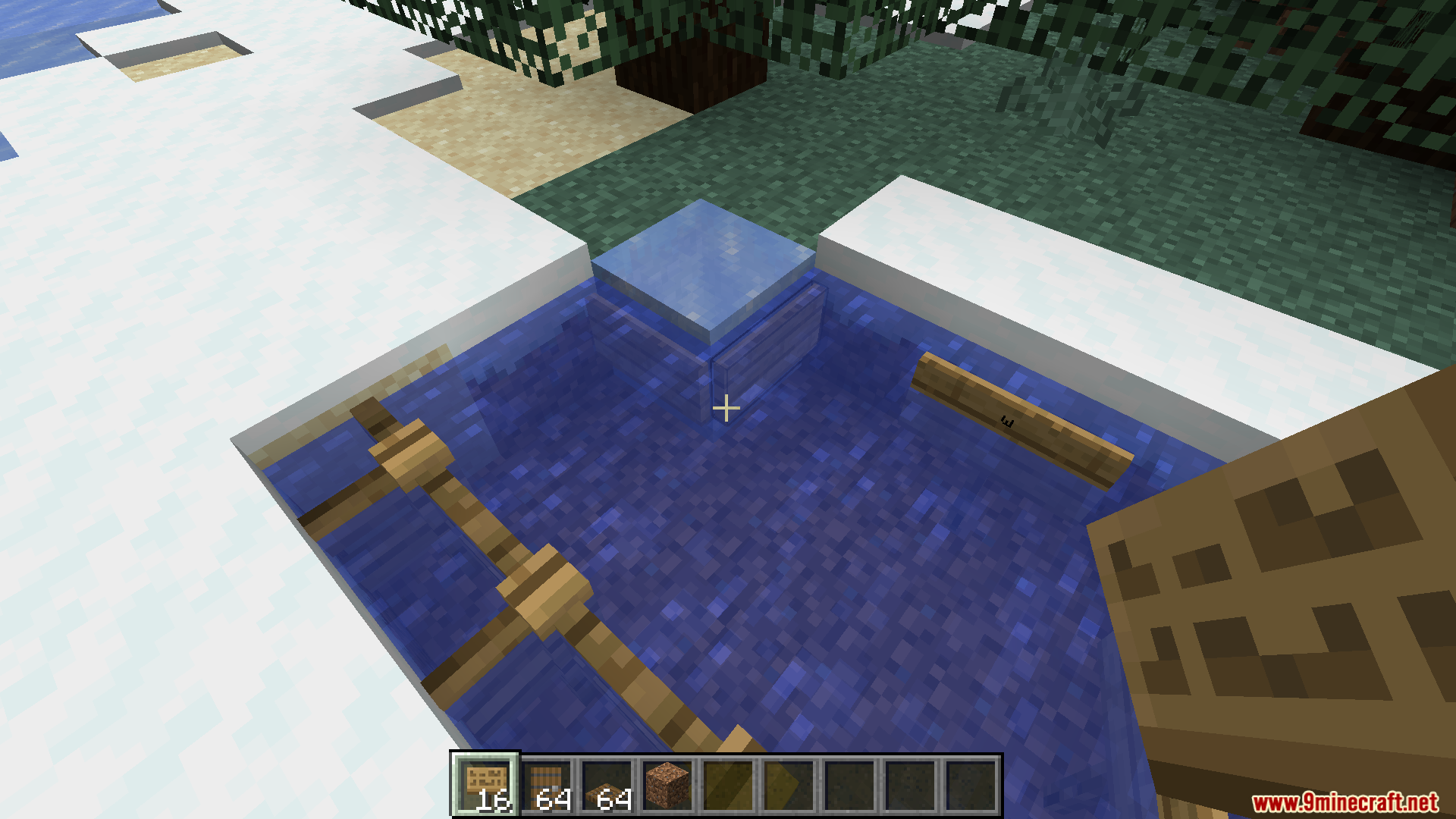 An ice block floating next to a waterlogged fence