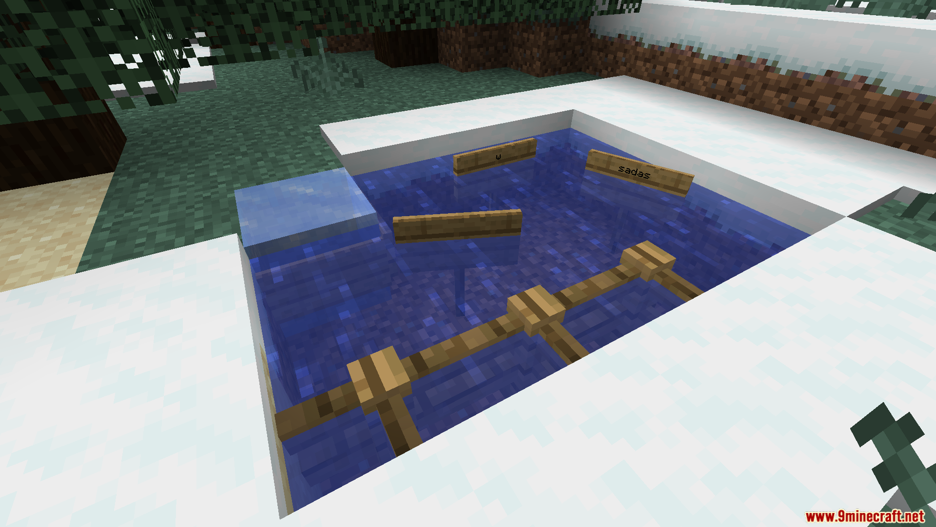 Multiple signs and a fence waterlogged in a snowy pool