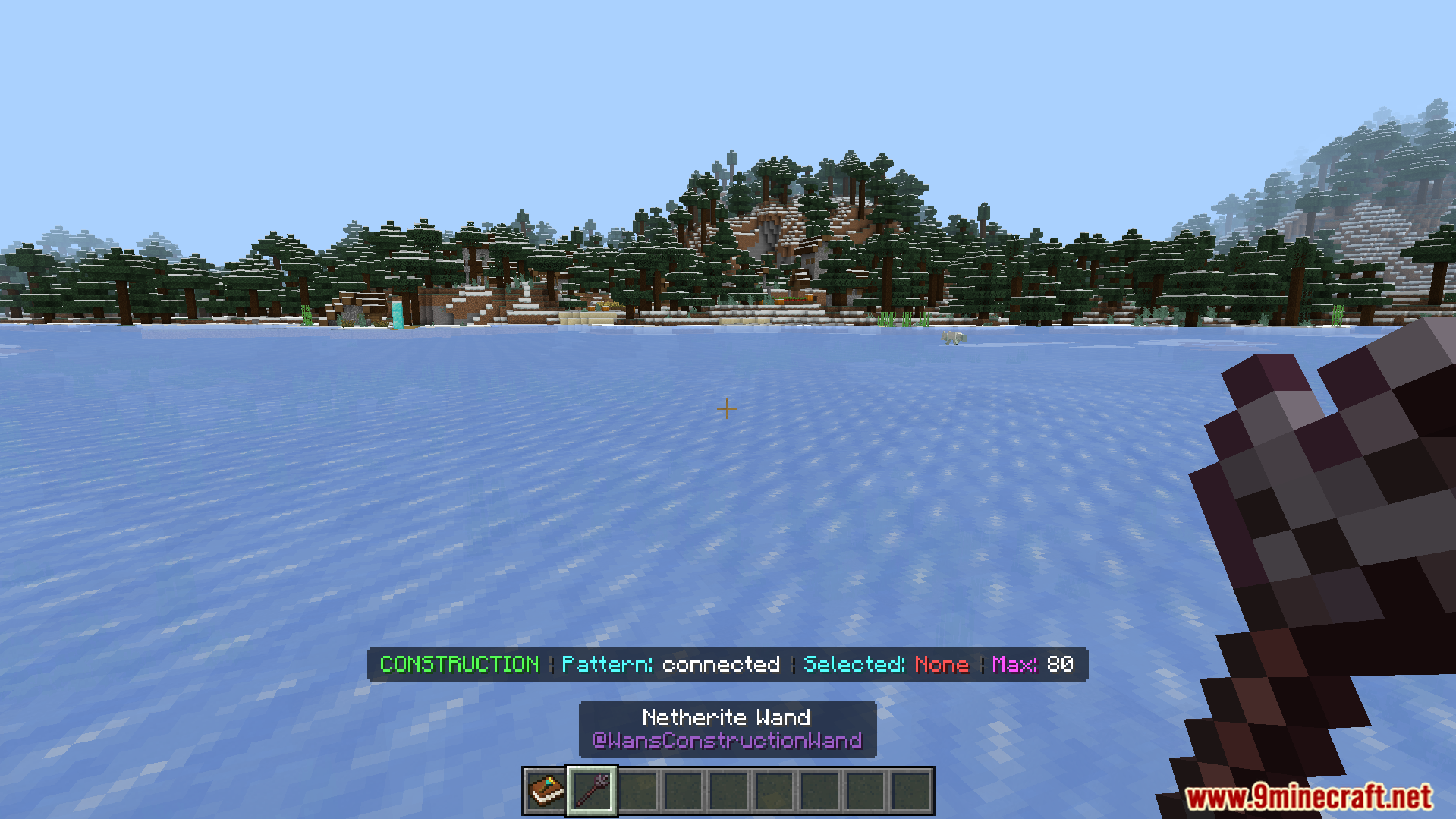 Player holding a netherite wand with construction mode active on ice