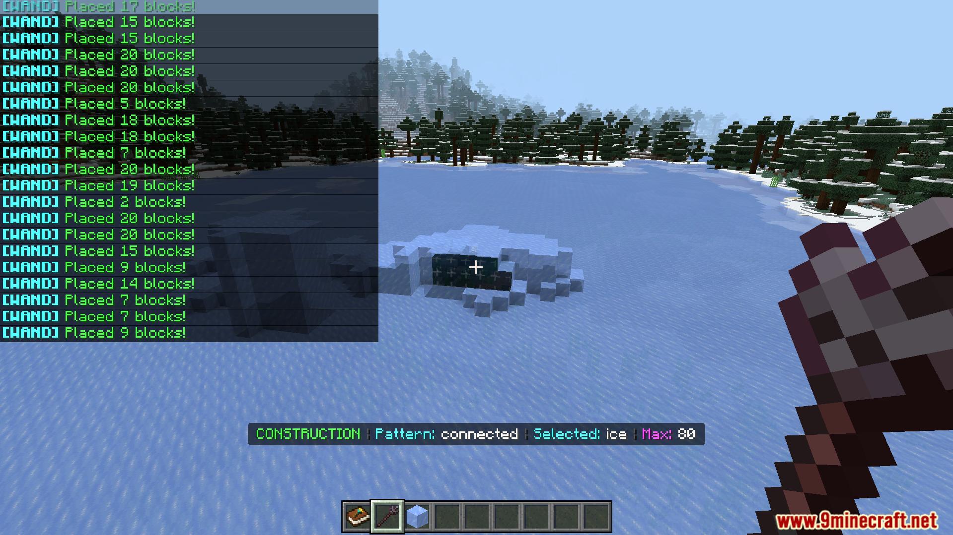 Player using construction wand to place connected ice blocks on frozen lake