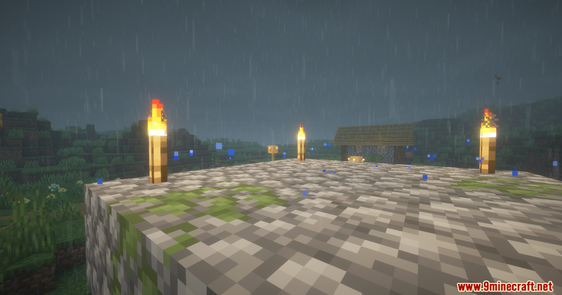 Cool Rain Reforged Mod Screenshot 4 Rain falling on a cobblestone platform creating blue splash particles near torches