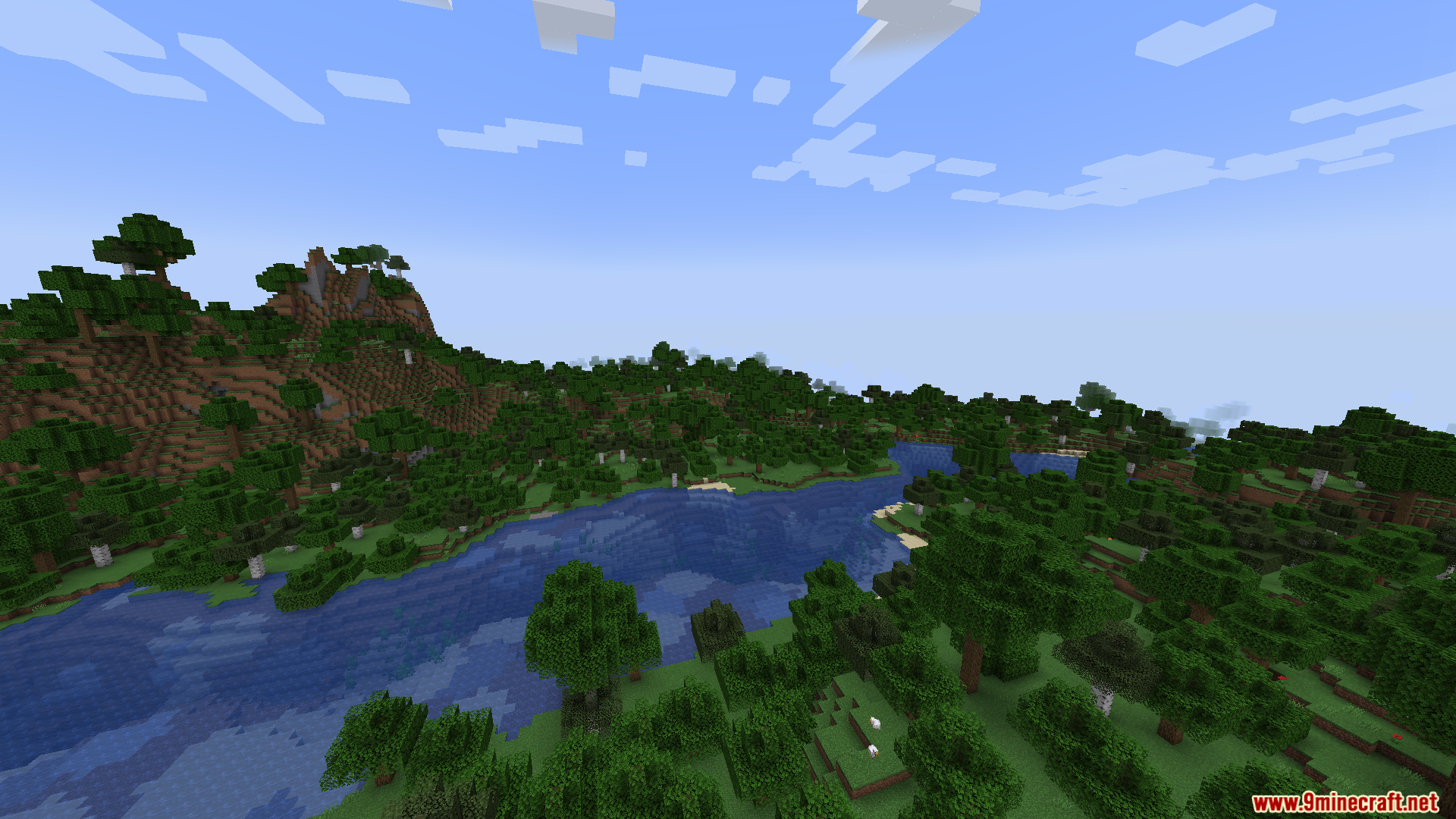 A wide river flowing through a lush, green forest biome