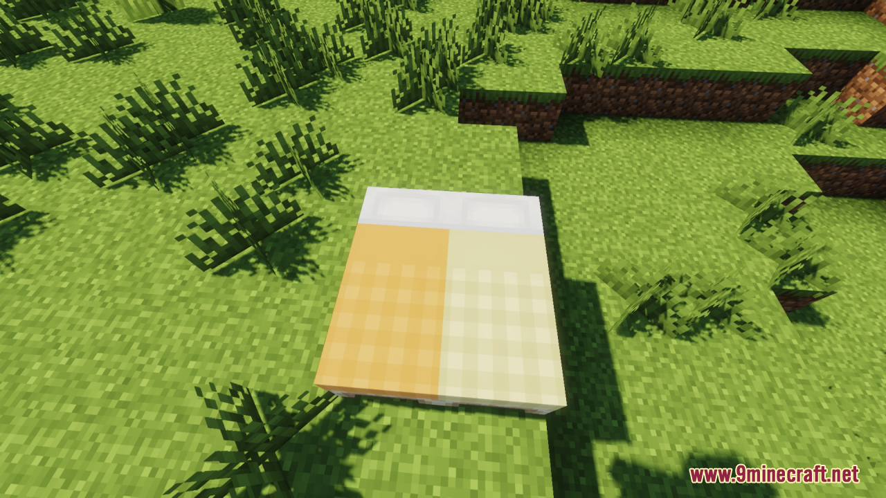 Cozy Nook Beds Resource Pack Screenshot 6 Orange and yellow plaid beds placed together on green grass in the game