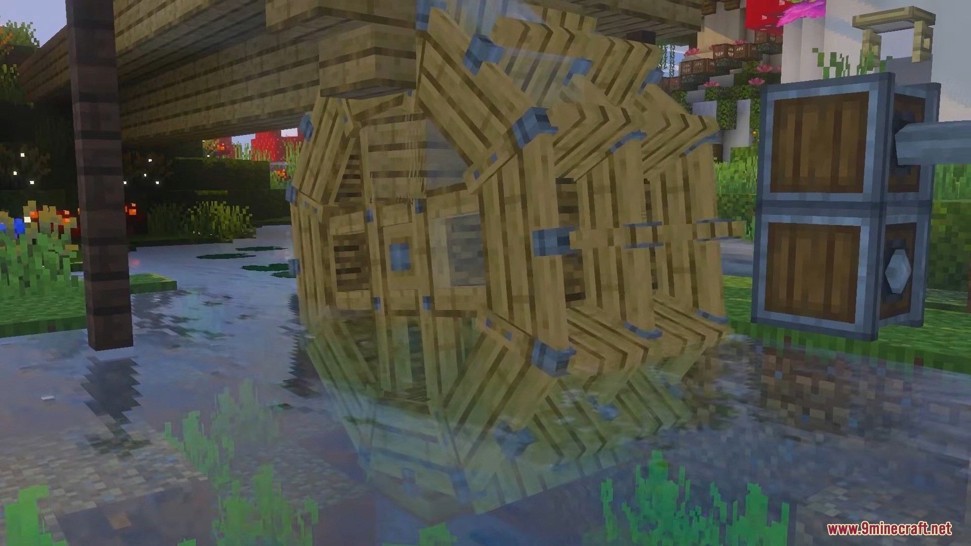 Large wooden water wheel structure placed in a shallow river generating power