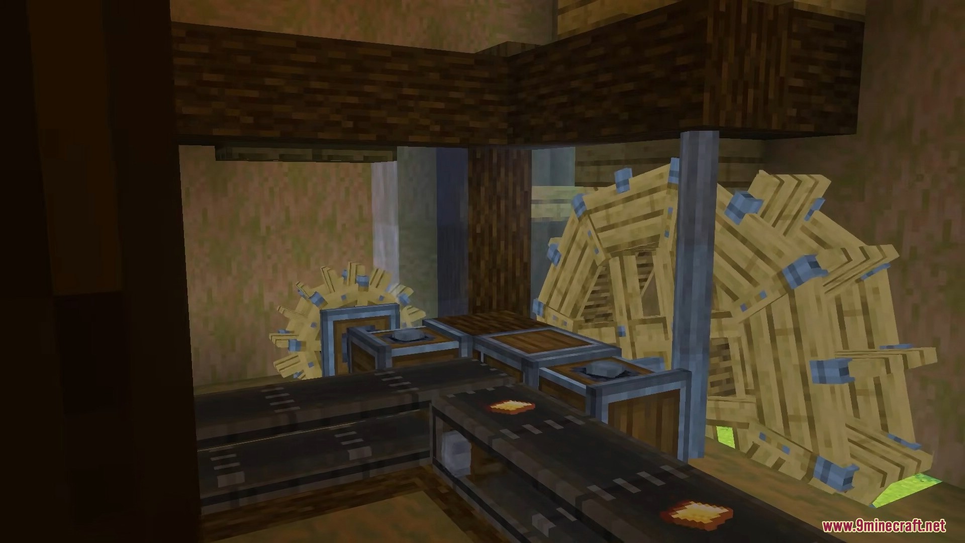 A complex machine setup featuring large wooden water wheels and conveyor belts