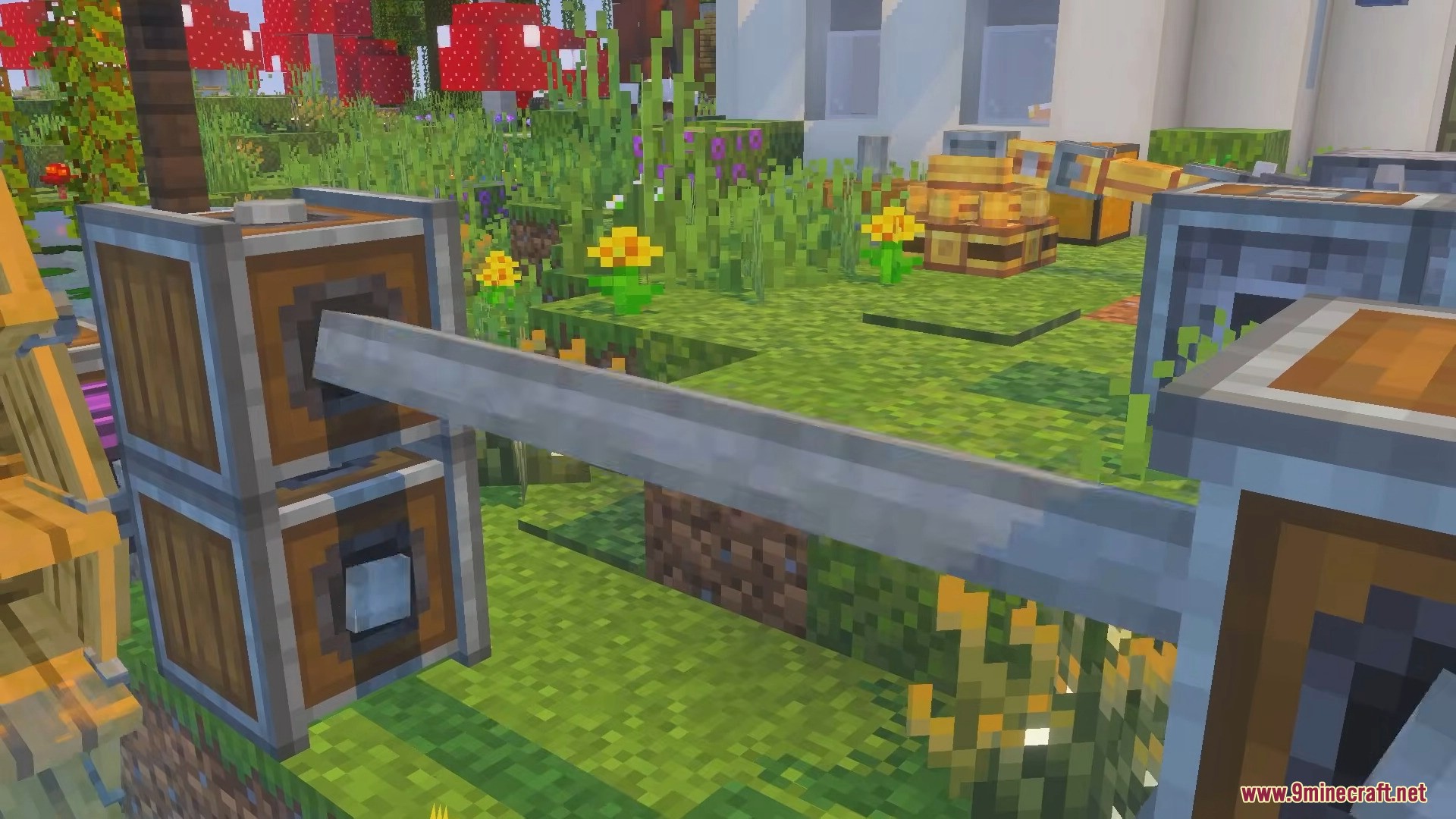 Wooden mechanical blocks connected by a metal shaft in a garden