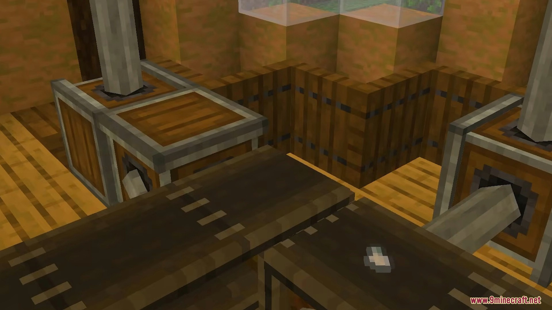 Conveyor belt moving small items between processing machines in a wooden factory setup