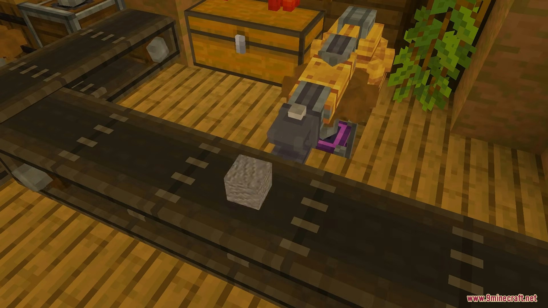 Mechanical arm interacting with a stone block on a conveyor belt near chests