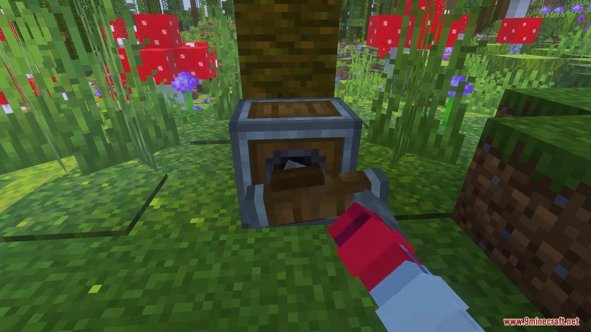 Player using a wrench tool on a mechanical saw block near a tree