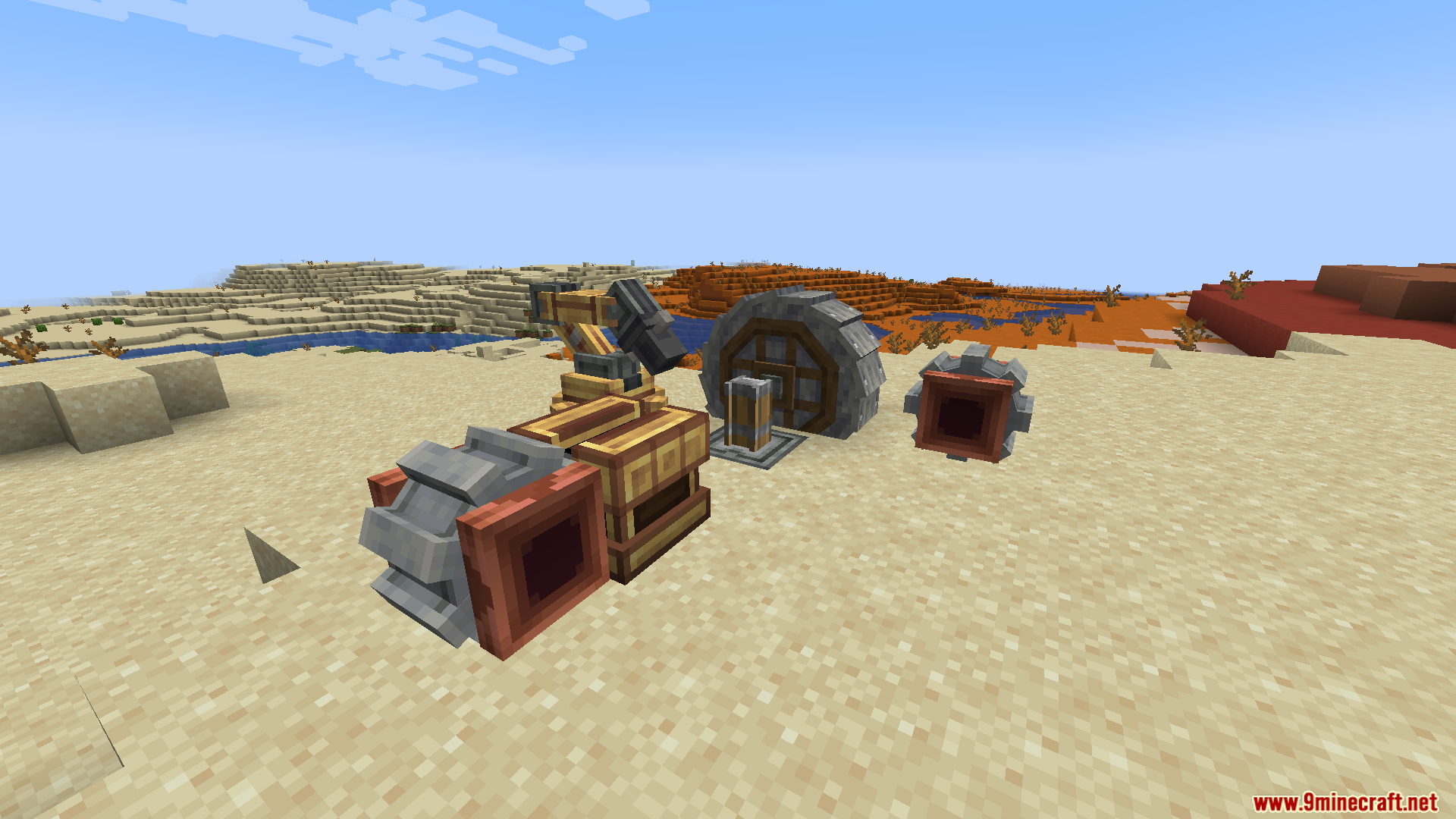 A mechanical arm and water wheel on the sand