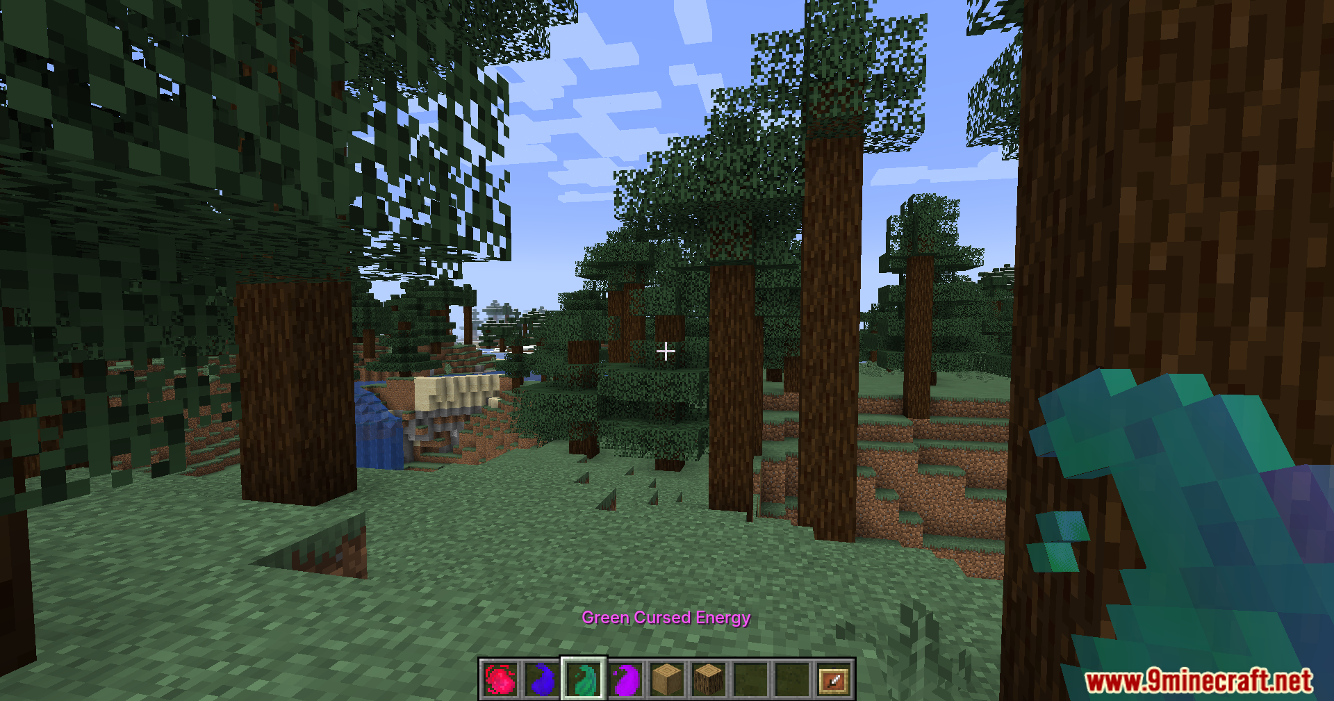 Player holding green cursed energy item in a forest