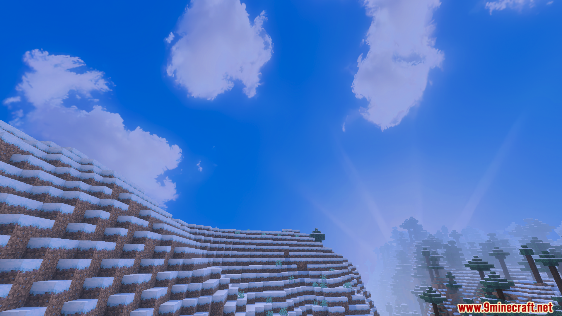 Custom Skies Cubemaps Addon Screenshot 3 Snowy mountain landscape under a bright blue sky with fluffy white clouds