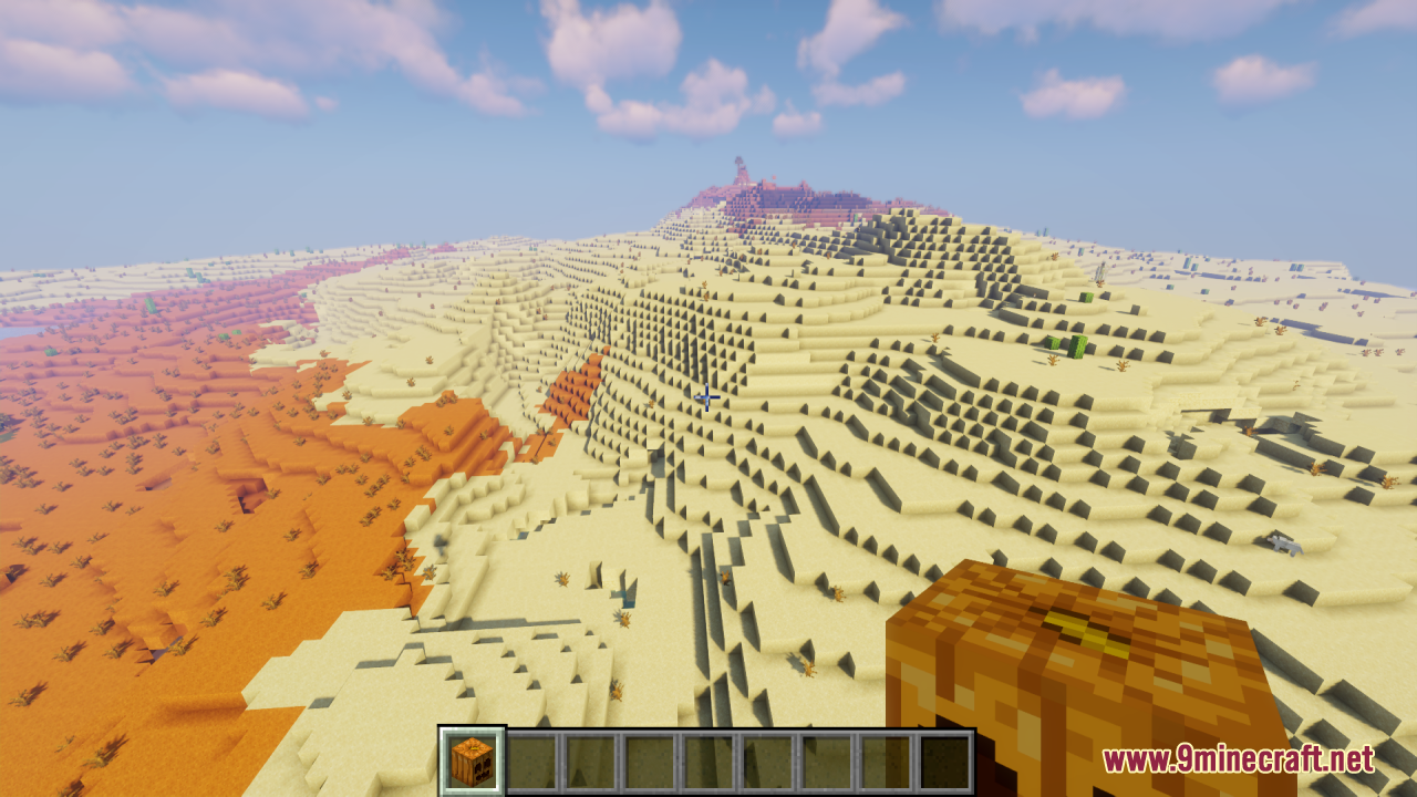 Player holding a smiling carved pumpkin in a desert biome