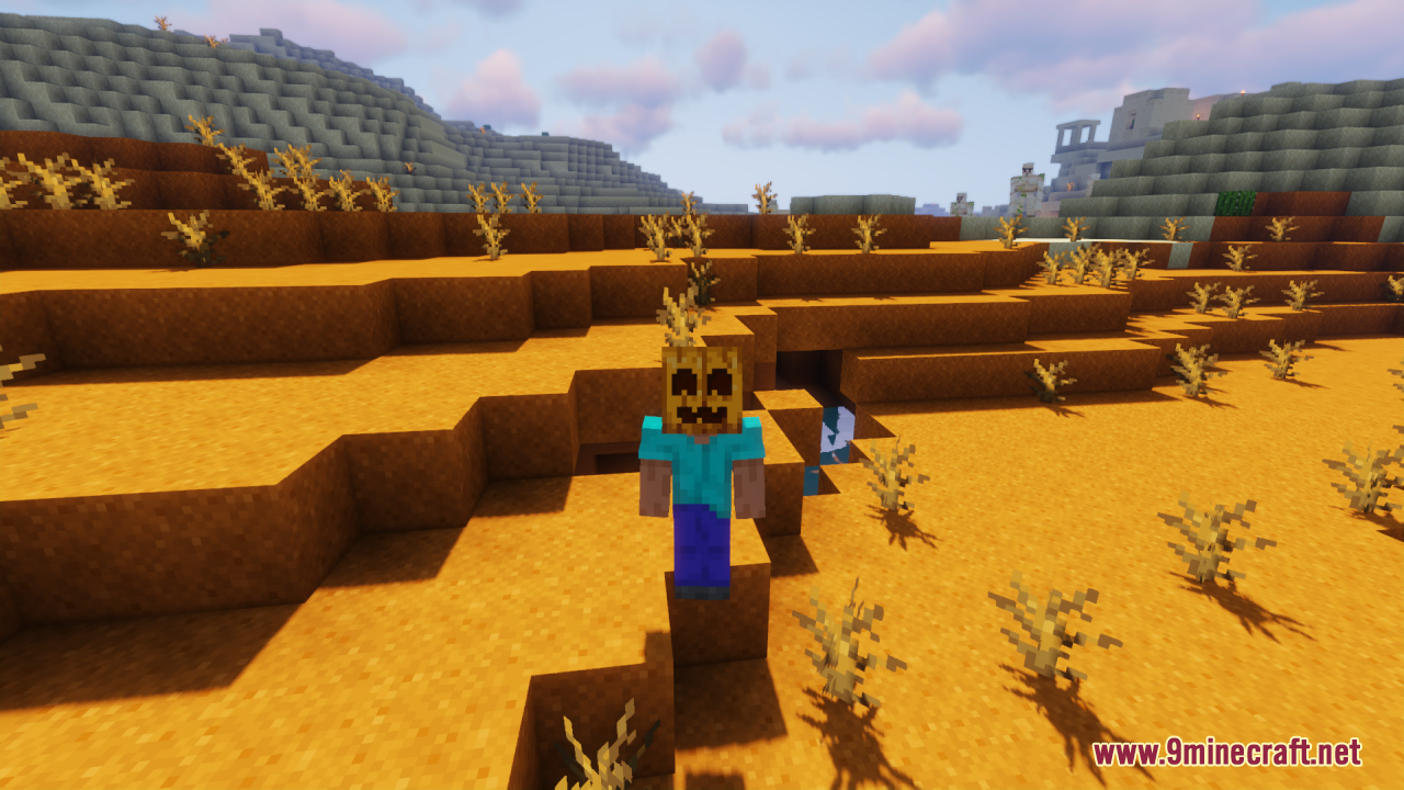 Minecraft player wearing a friendly smiling pumpkin mask in a badlands biome