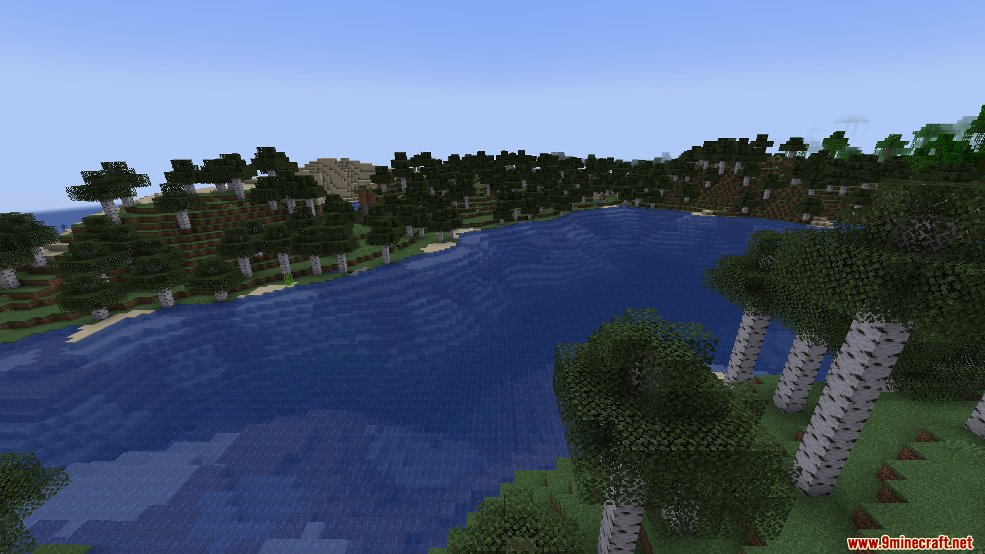 DLC Manager Mod Screenshot 6 Scenic landscape with a wide blue lake surrounded by a birch forest