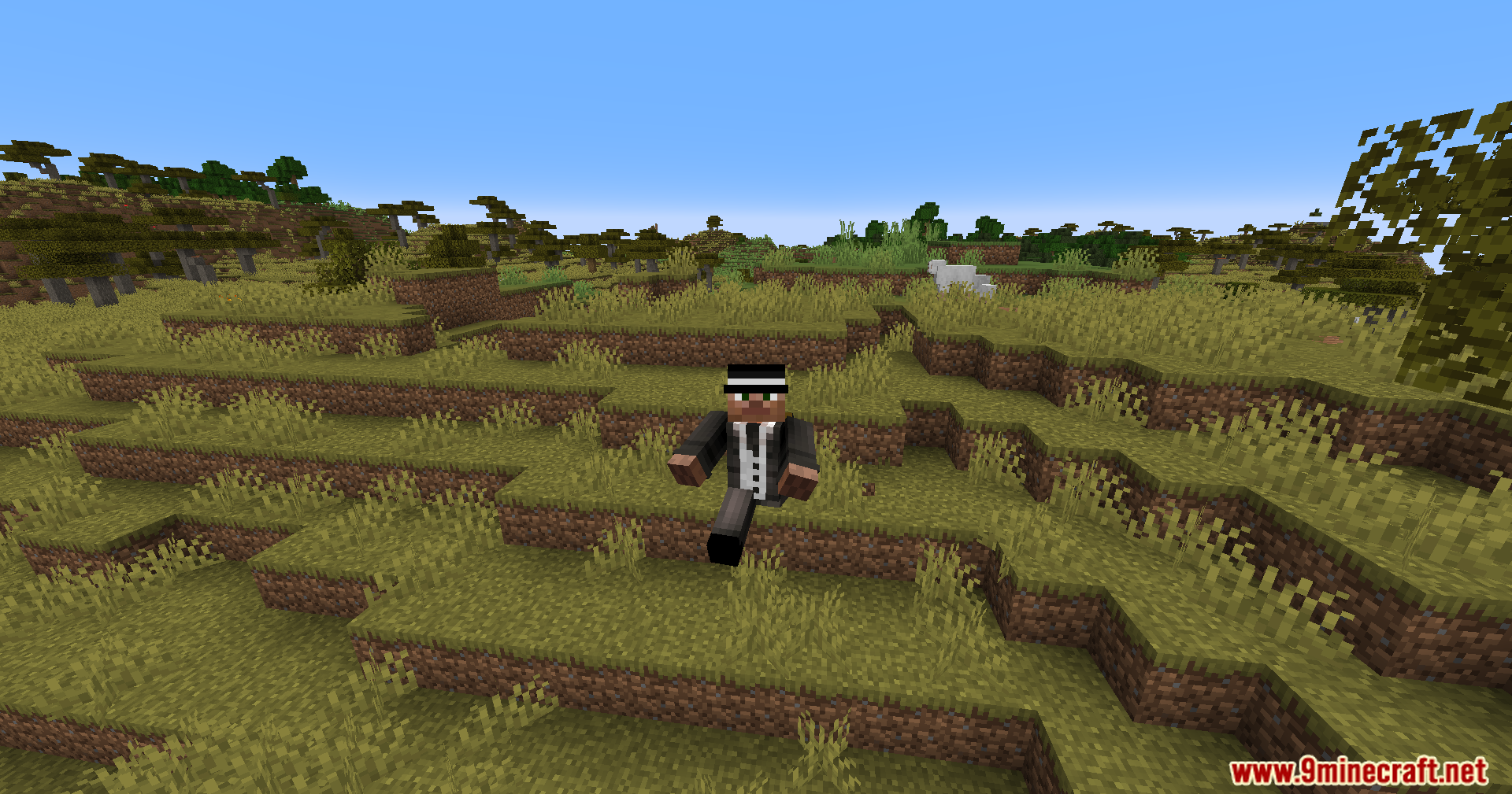 Player in a black suit jumping through the air in a savanna