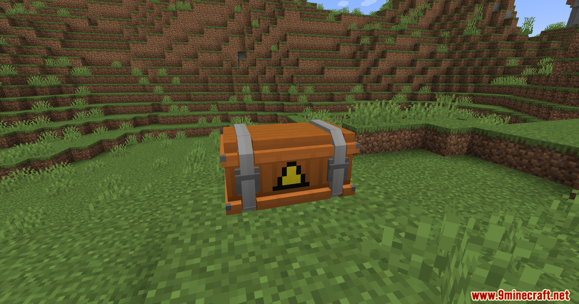 An orange supply crate with a yellow triangular symbol