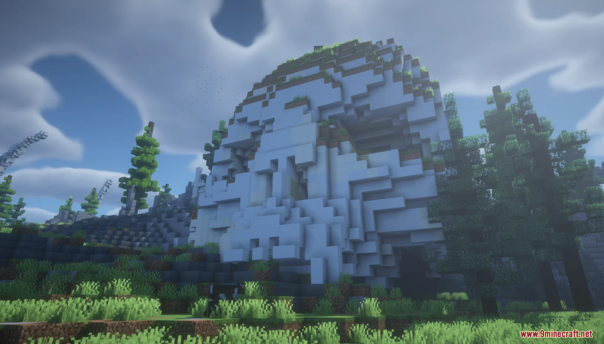 A giant white skull structure built into a grassy hillside