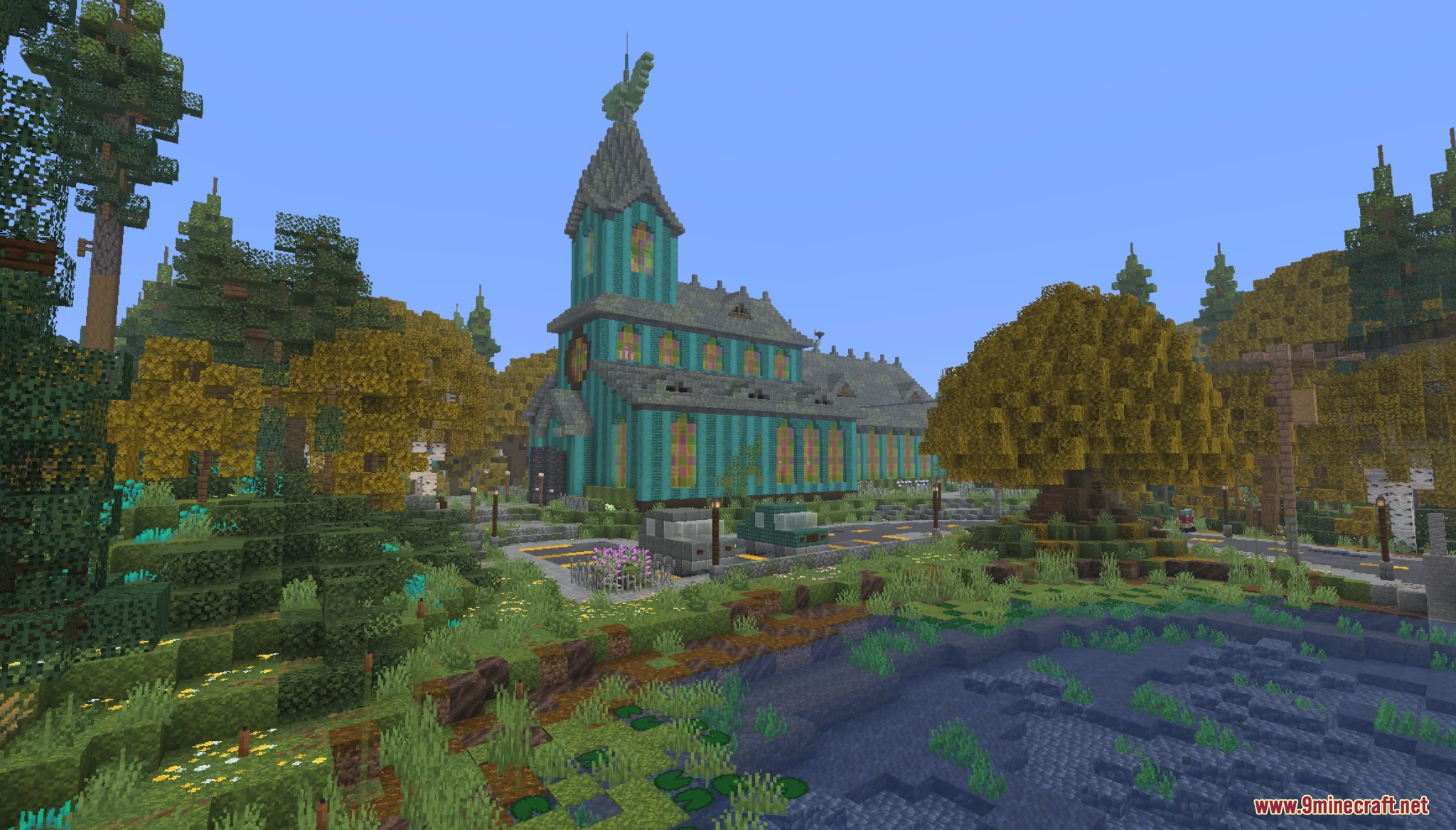 Large teal mansion surrounded by autumn trees