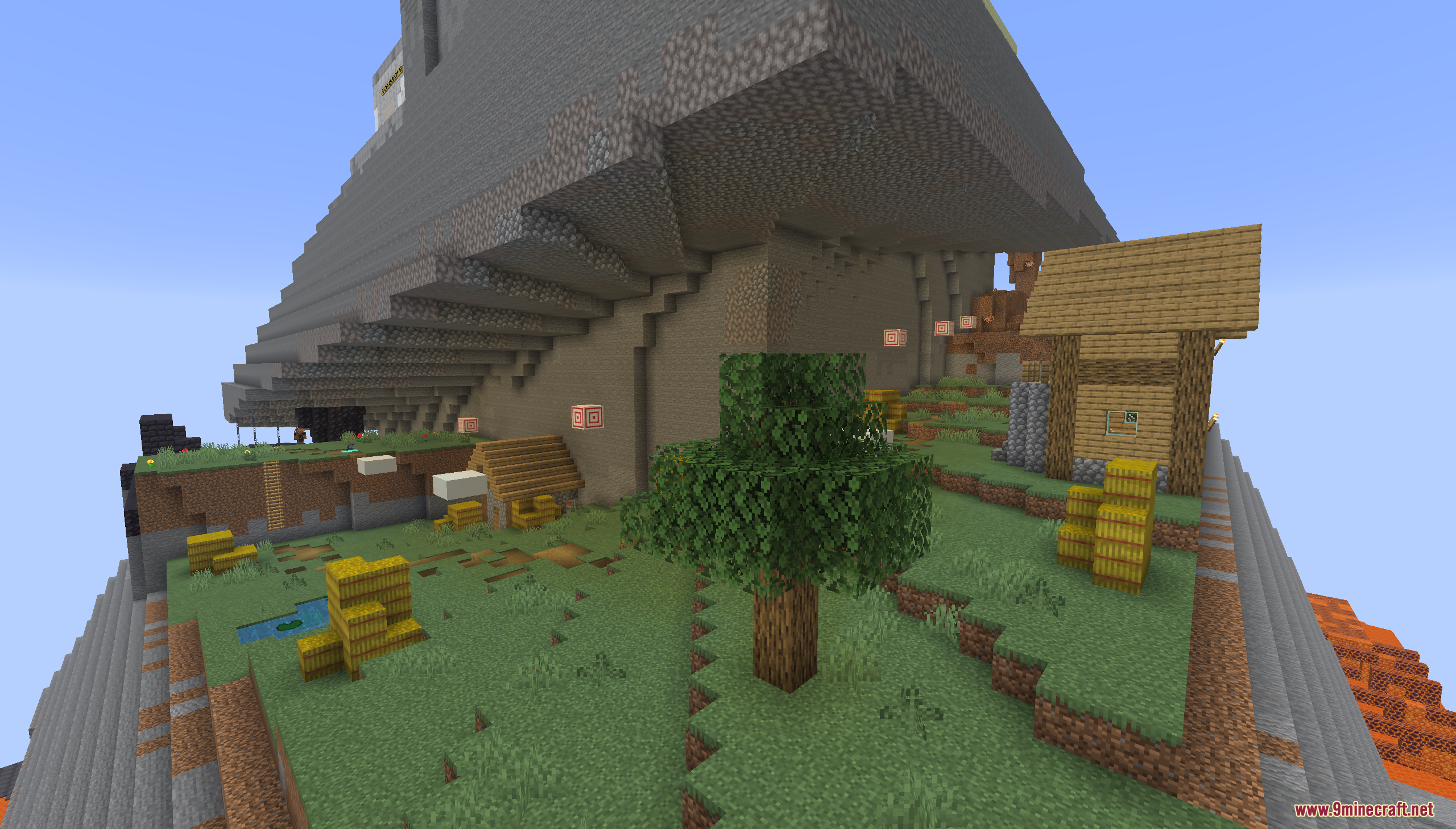 A peaceful village with a small house and hay bales