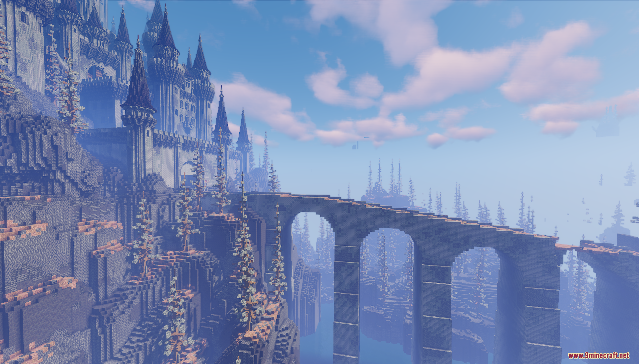 Side view of a massive gothic castle and a long arched stone bridge
