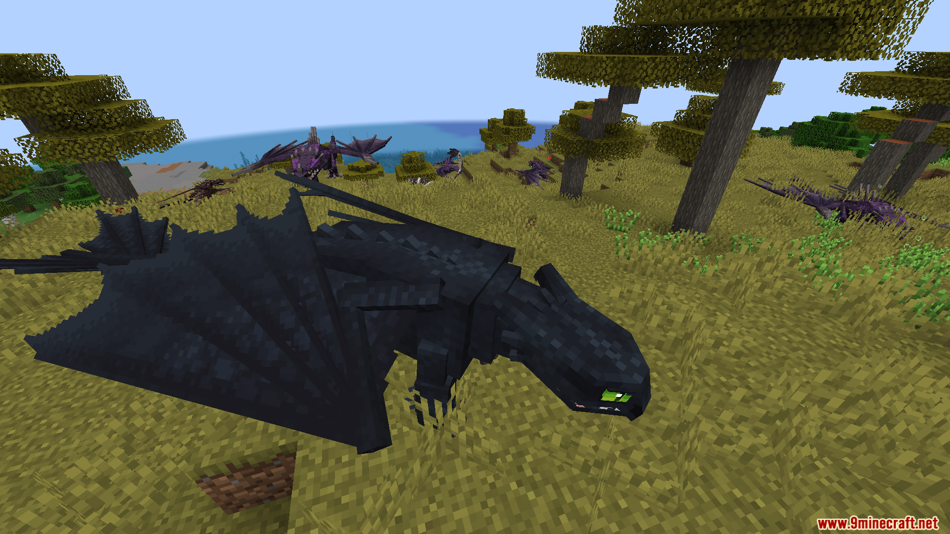 A large black dragon resting on a grassy hill in a savanna biome