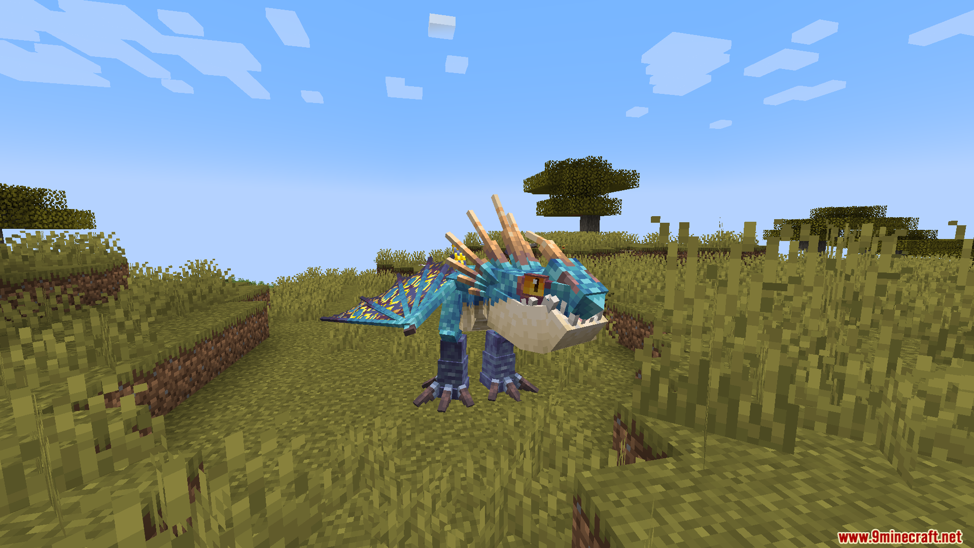 A bright blue and yellow dragon standing upright in a grassy field