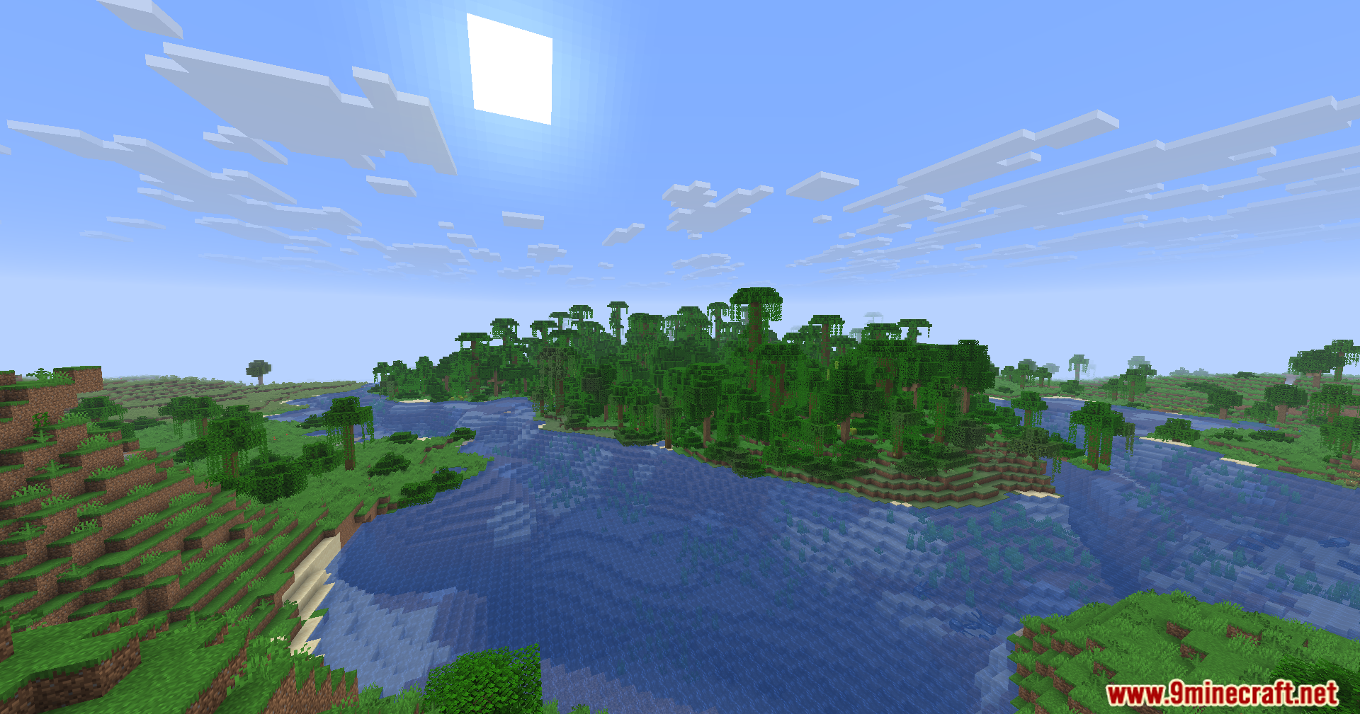 Fake Fabric Loader Mod Screenshot 10 A dense jungle forest biome bordering a wide blue river under sunny skies