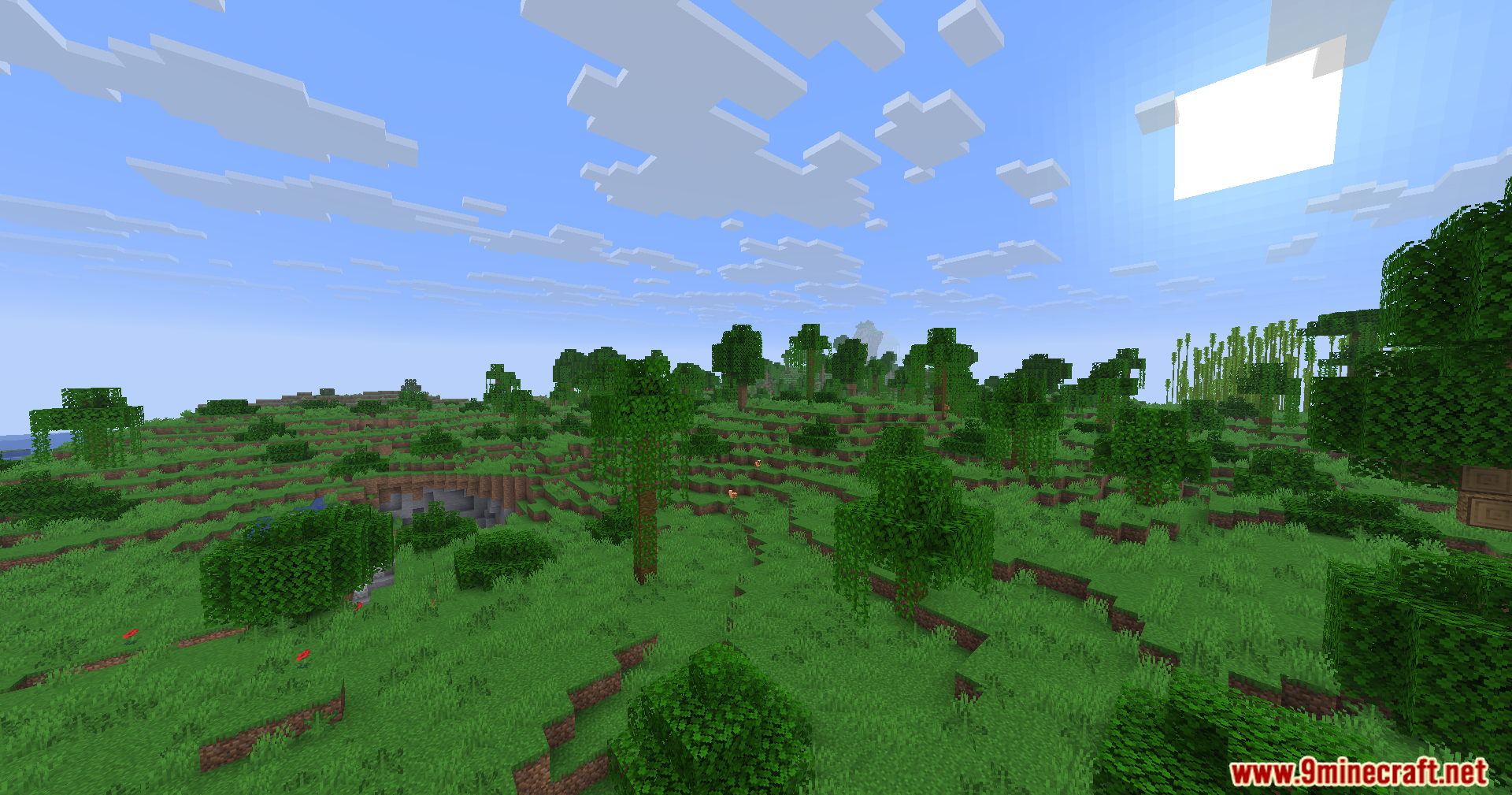 Fake Fabric Loader Mod Screenshot 7 Wide view of a grassy Minecraft landscape with scattered trees under sunny sky