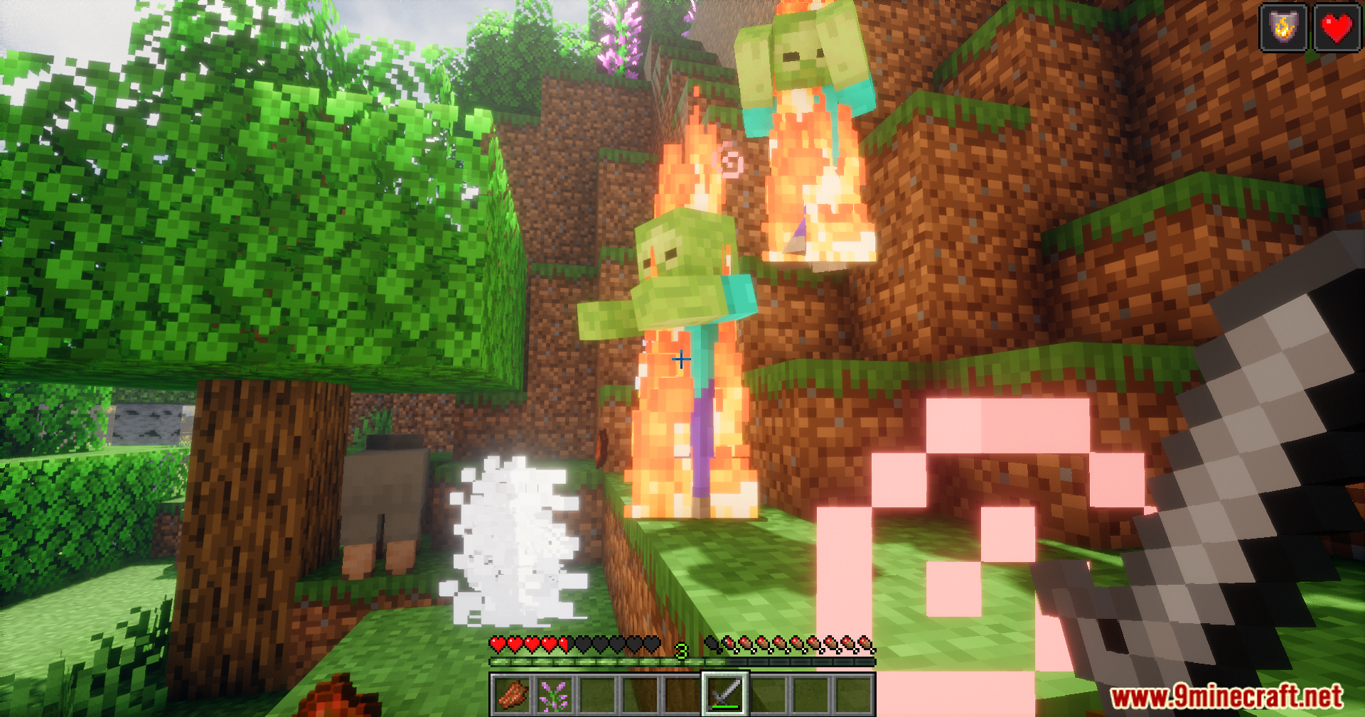Player fighting two burning zombies with a sword in daylight