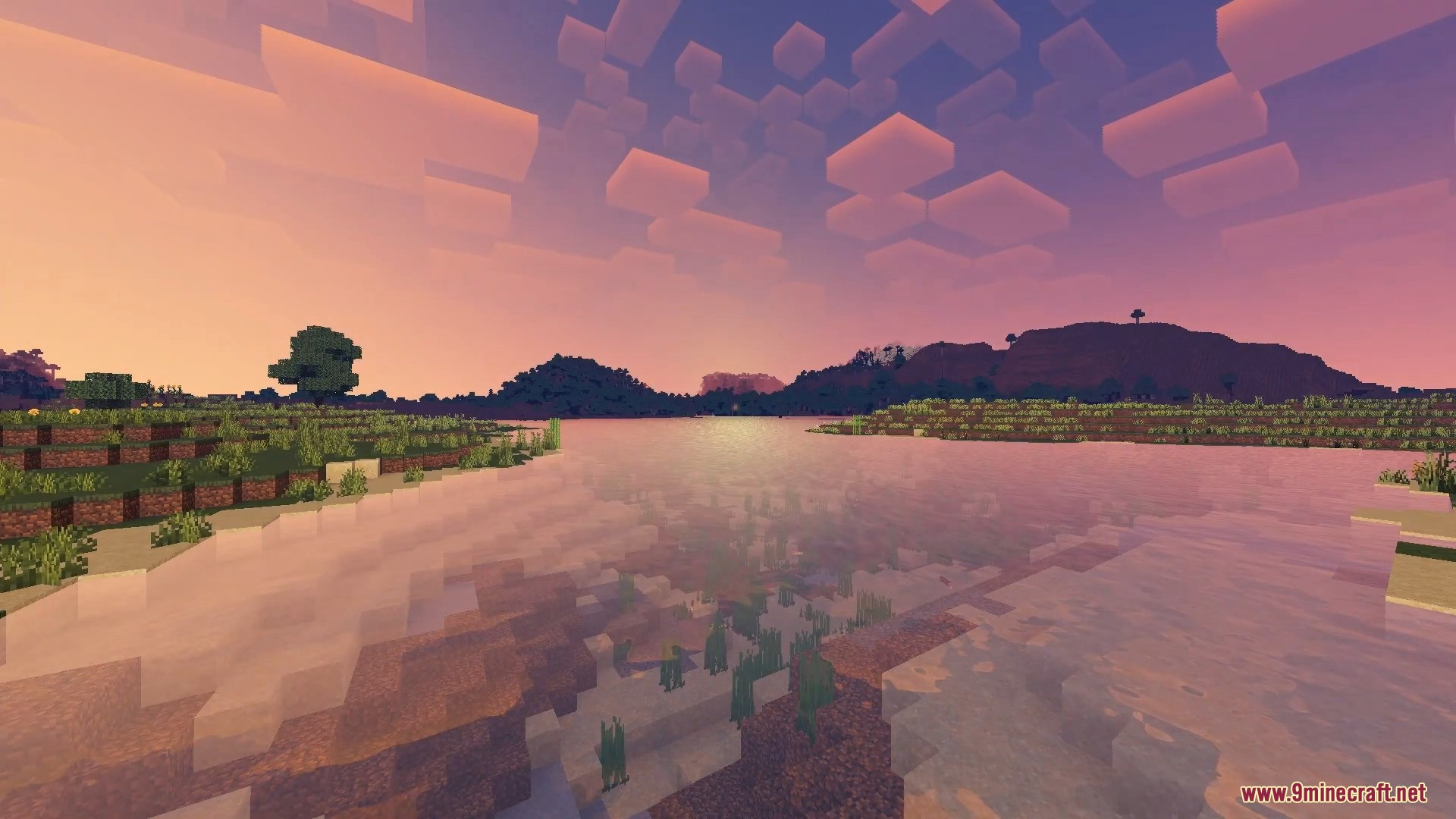 FirmamentCraft 5.0 Shader Screenshot 13 Scenic Minecraft sunset showing calm water reflections and blocky clouds over distant hills