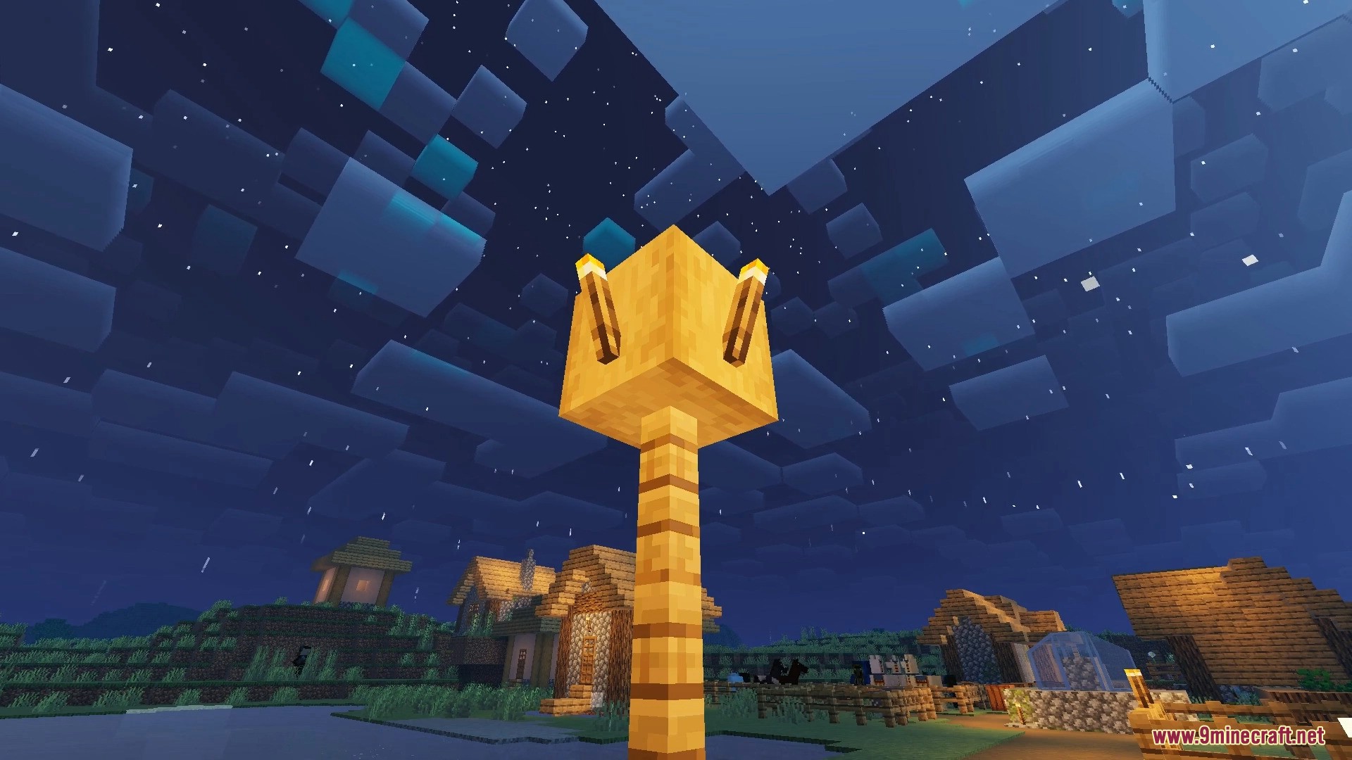 FirmamentCraft 5.0 Shader Screenshot 15 Nighttime view of a village with a glowing gold block lamp post