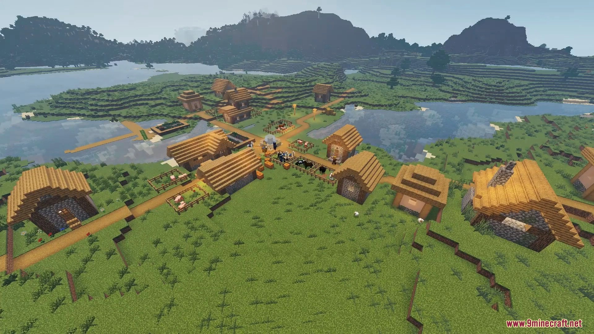 FirmamentCraft 5.0 Shader Screenshot 2 Aerial view of a Minecraft village located near a river with realistic lighting