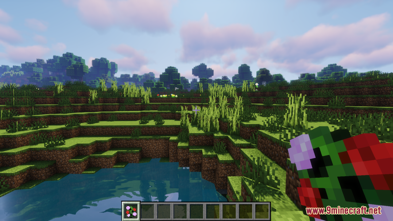 Floral Creeper Resource Pack Screenshot 2 Player holding a colorful floral creeper item in a grassy landscape near water