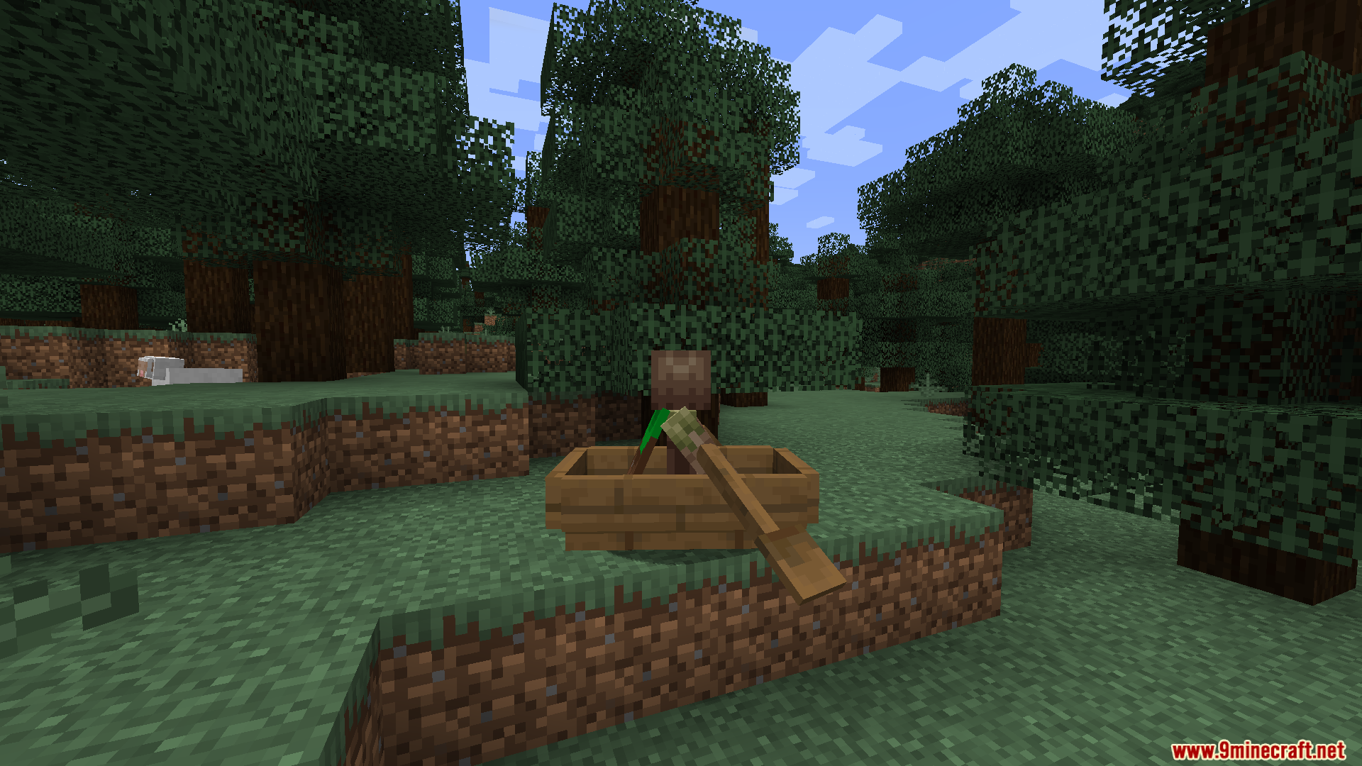 Empty wooden boat on grass showing custom resting oar positions in forest