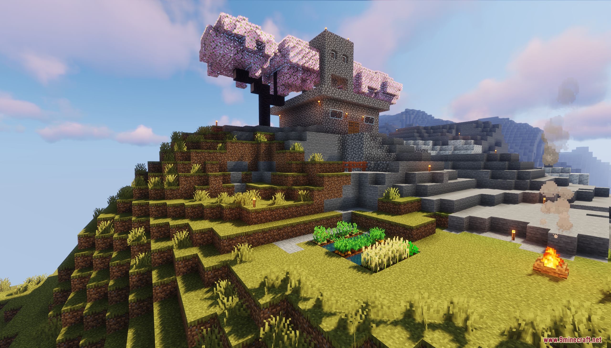 A hillside house with a small farm and a campfire