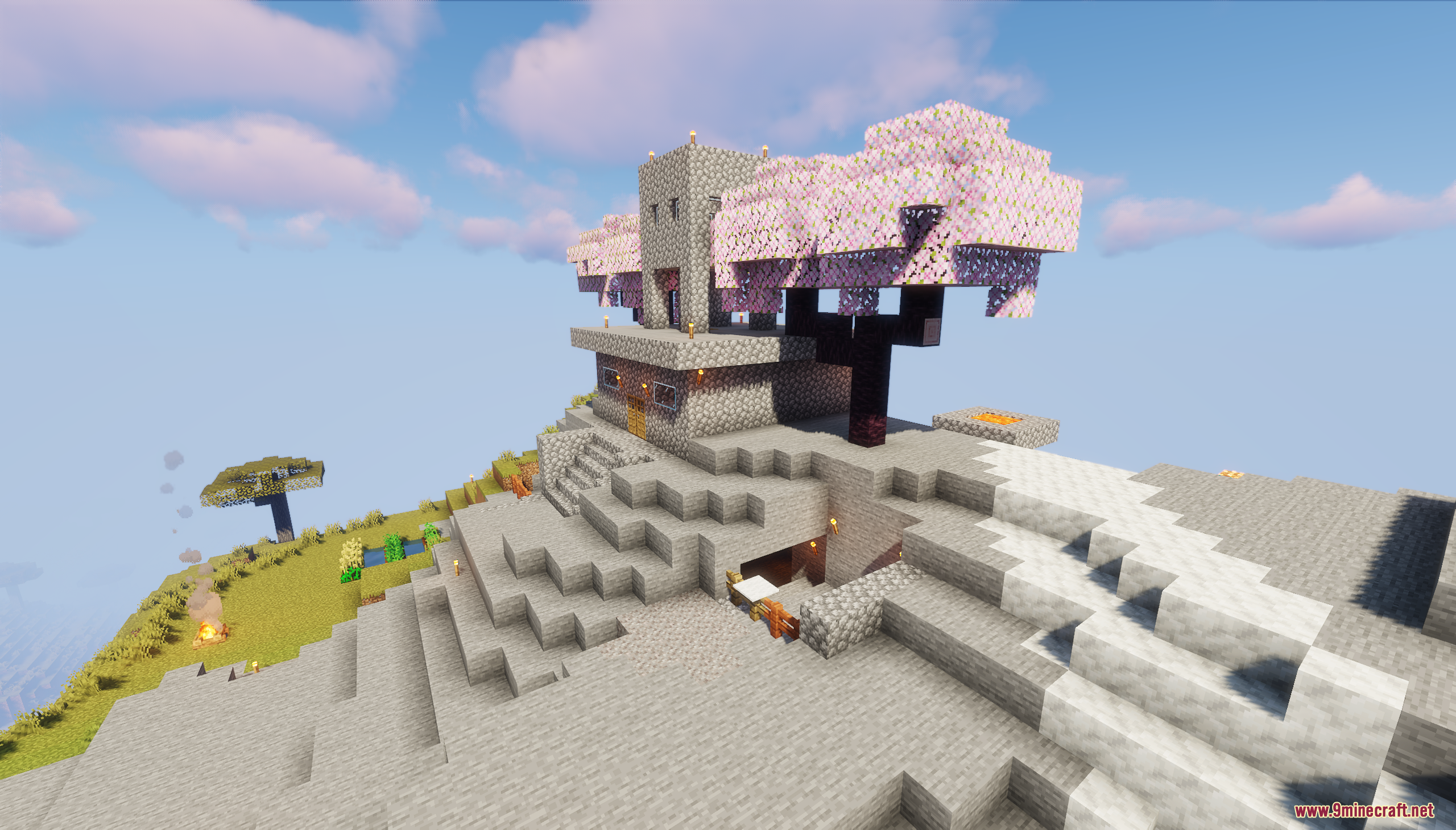 A stone house built beside a large cherry blossom tree