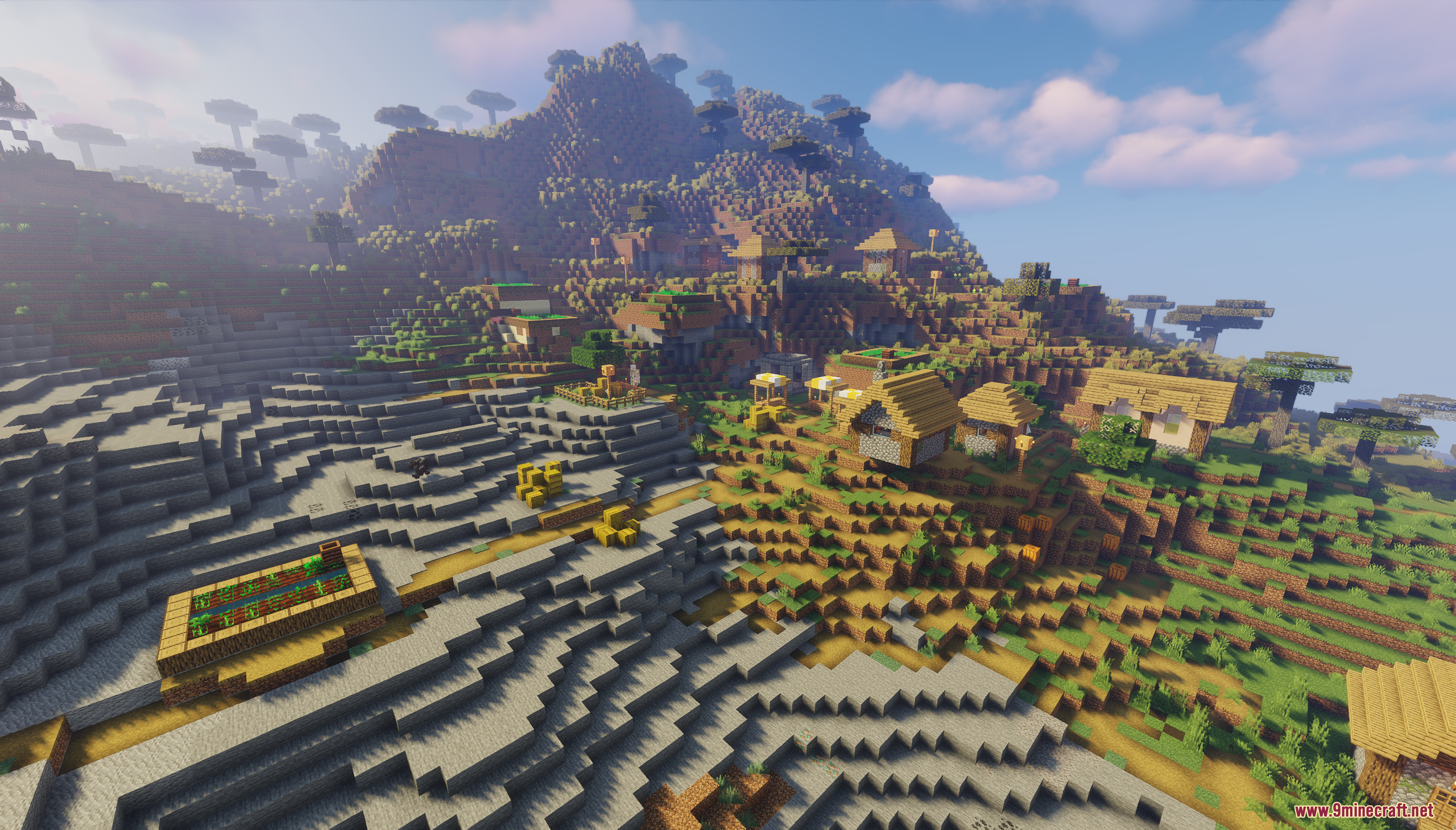 A sprawling savanna village on a terraced mountainside