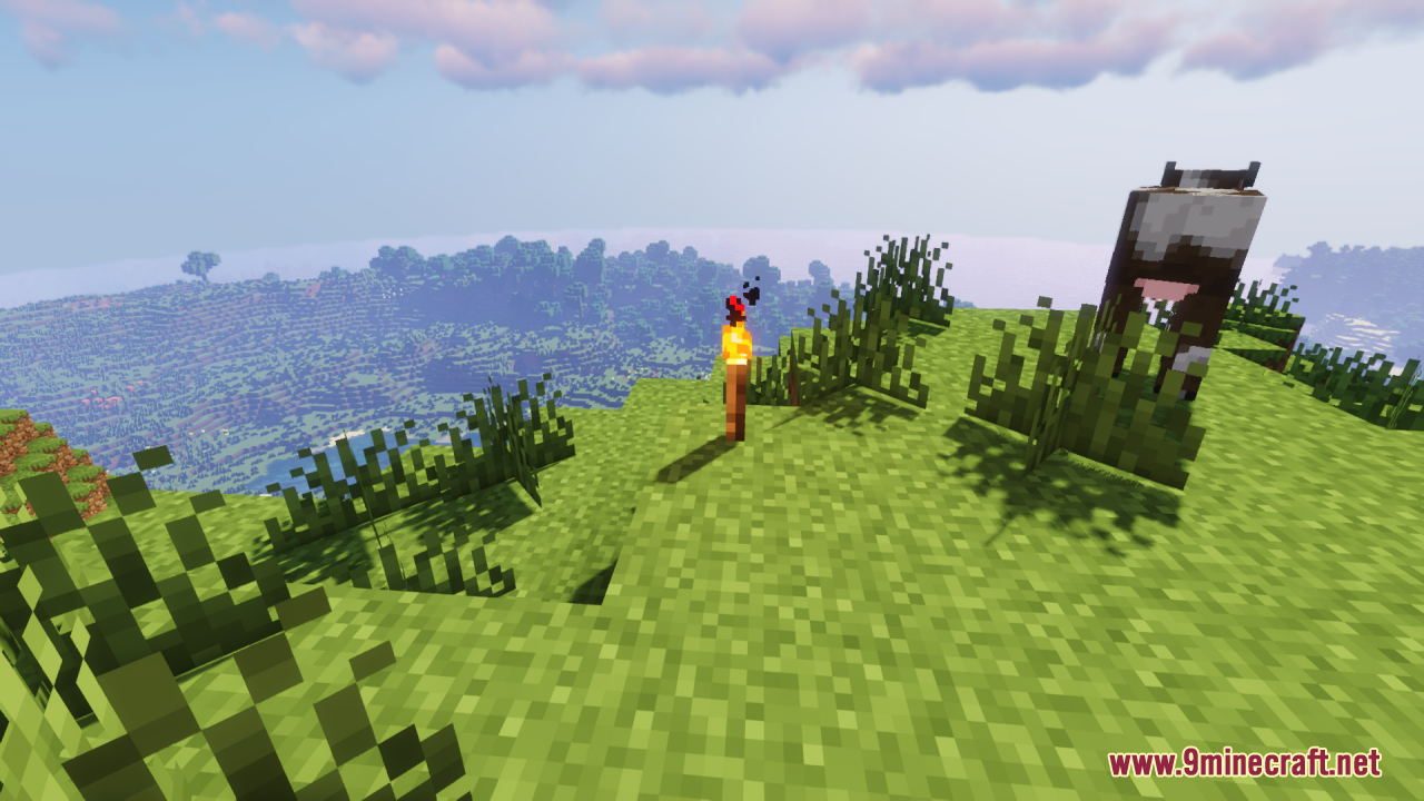 A 3D torch model placed on a grassy hill