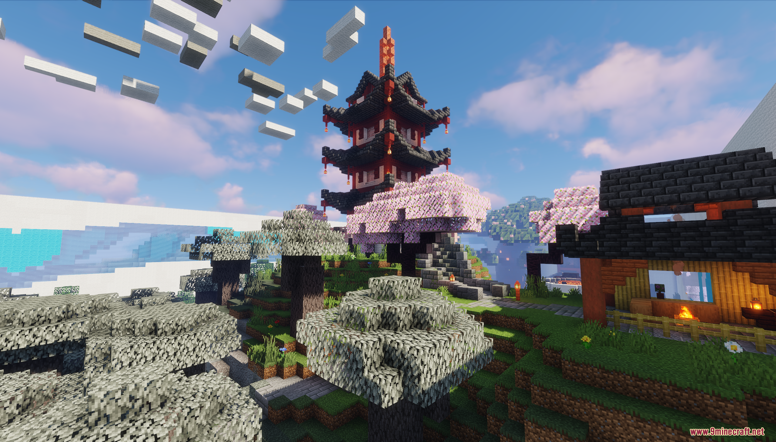 A Japanese pagoda stands atop a hill with cherry blossoms