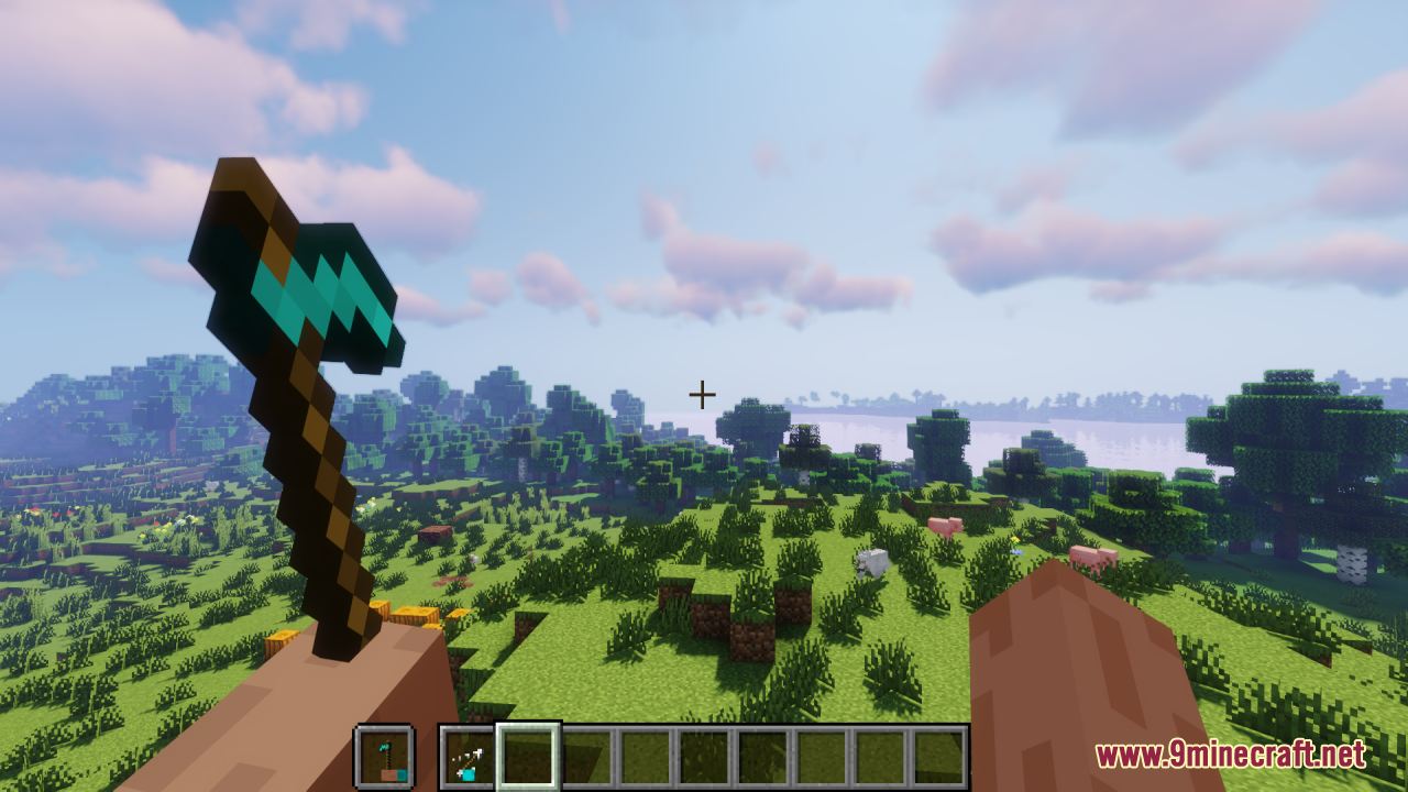 Hold in Hands Resource Pack Screenshot 7 Player holding a diamond hoe with visible hands in a grassy landscape