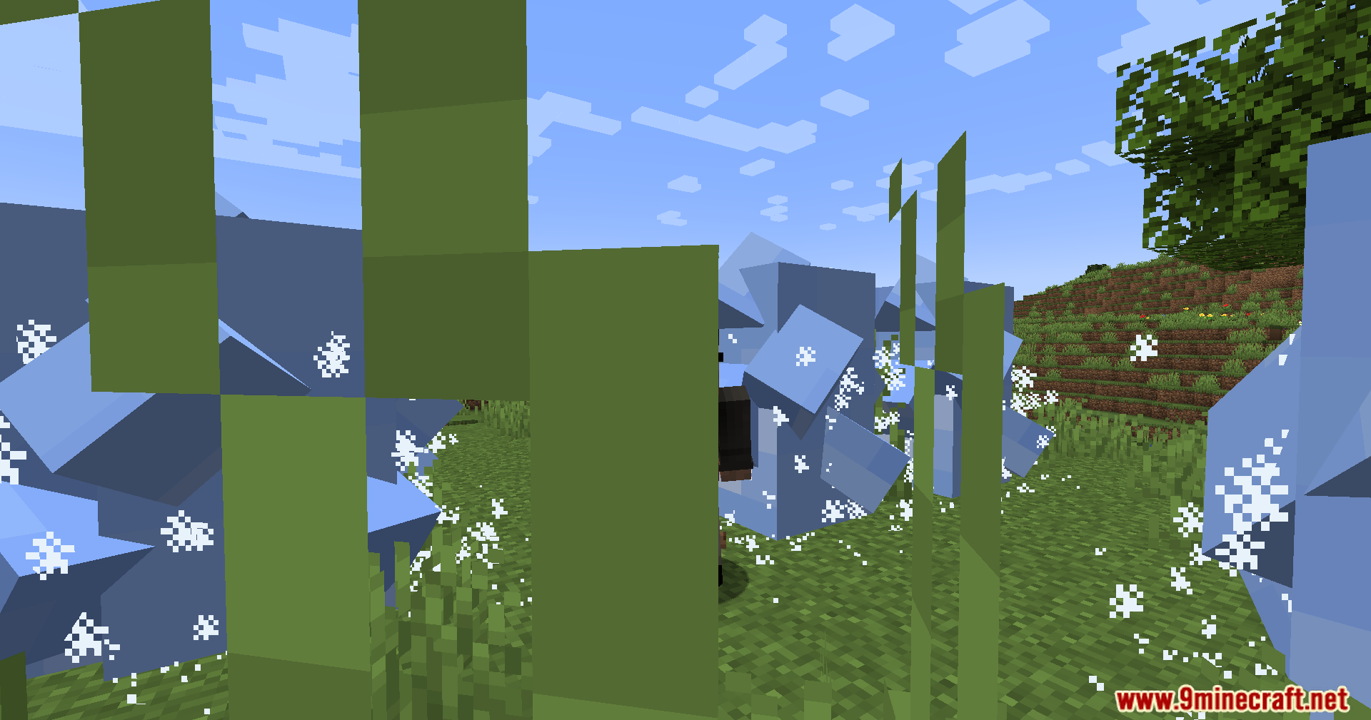 Ice Formation Cursed Fate Addon Mod Screenshot 10 Player standing among large blue ice blocks and frost particles behind tall grass
