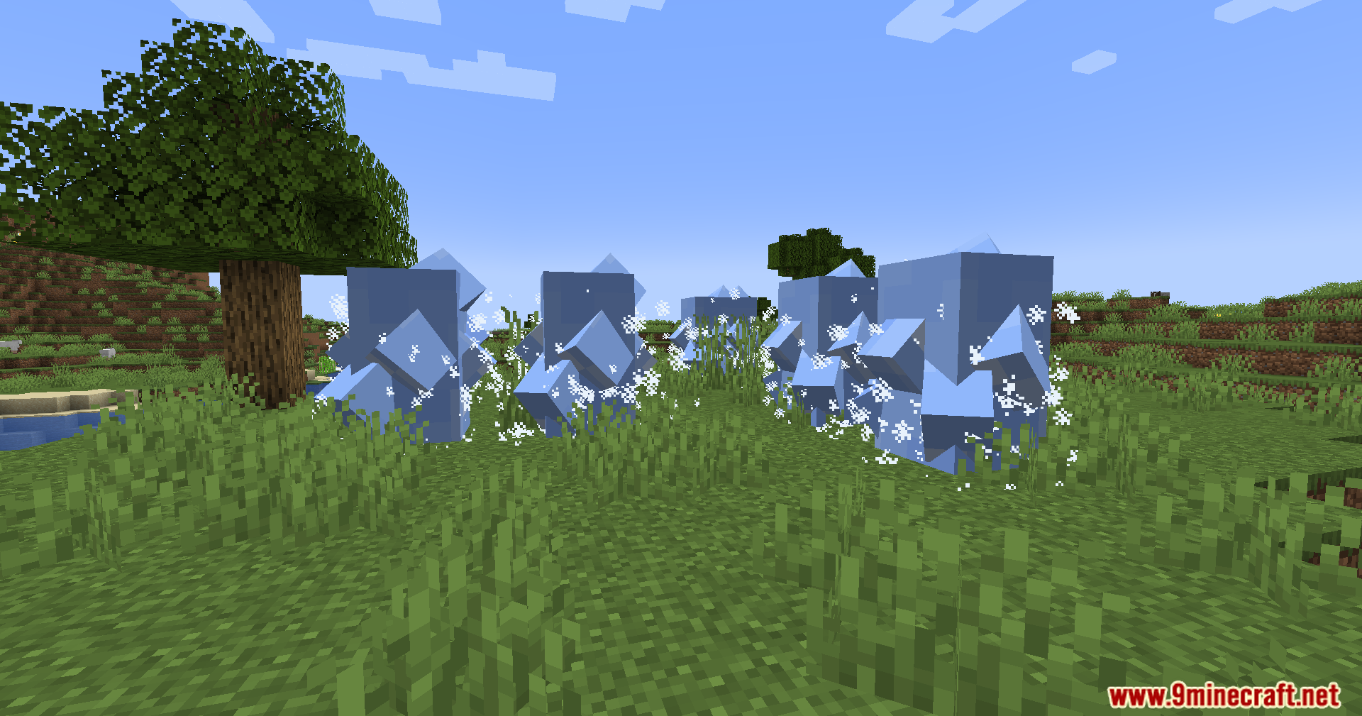 Ice Formation Cursed Fate Addon Mod Screenshot 8 Large blue ice pillars summoned in a grassy field with white frost particles