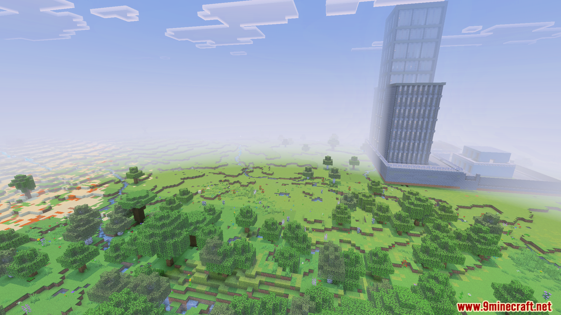 Tall grey building next to forest and desert