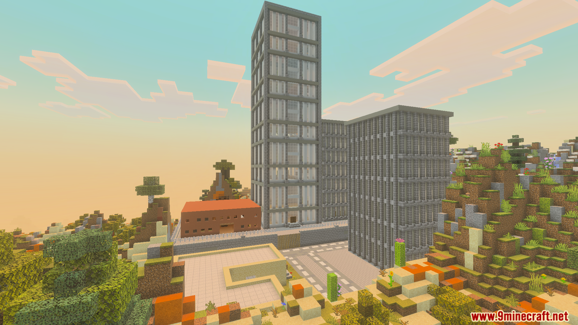 Several tall buildings and a road in a desert