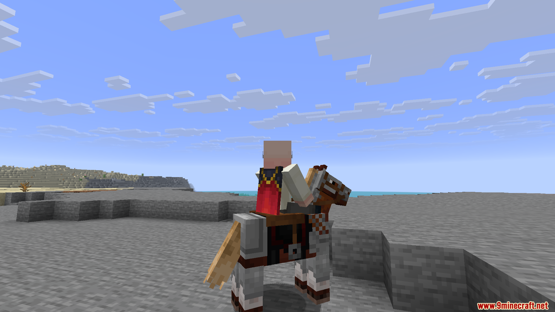 A player with a red cape riding a horse on a beach