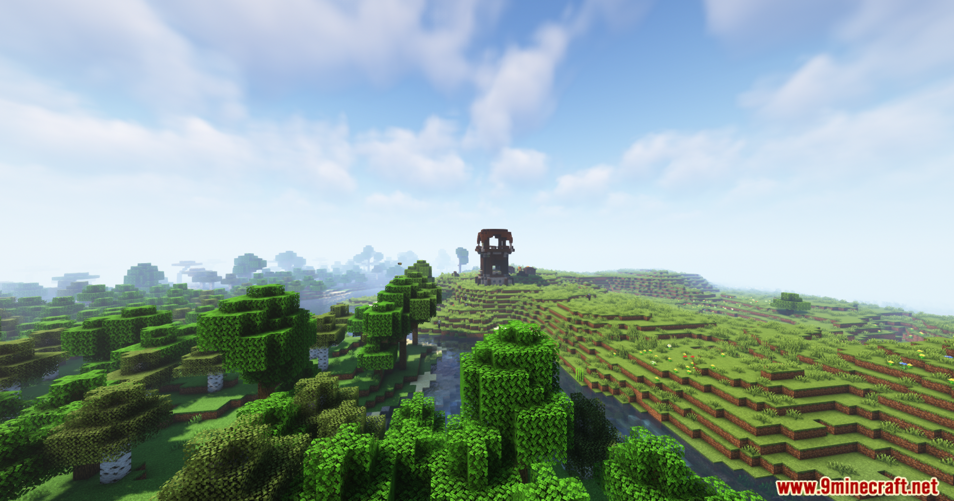 A winding river separating a forest from grassy plains with a pillager outpost