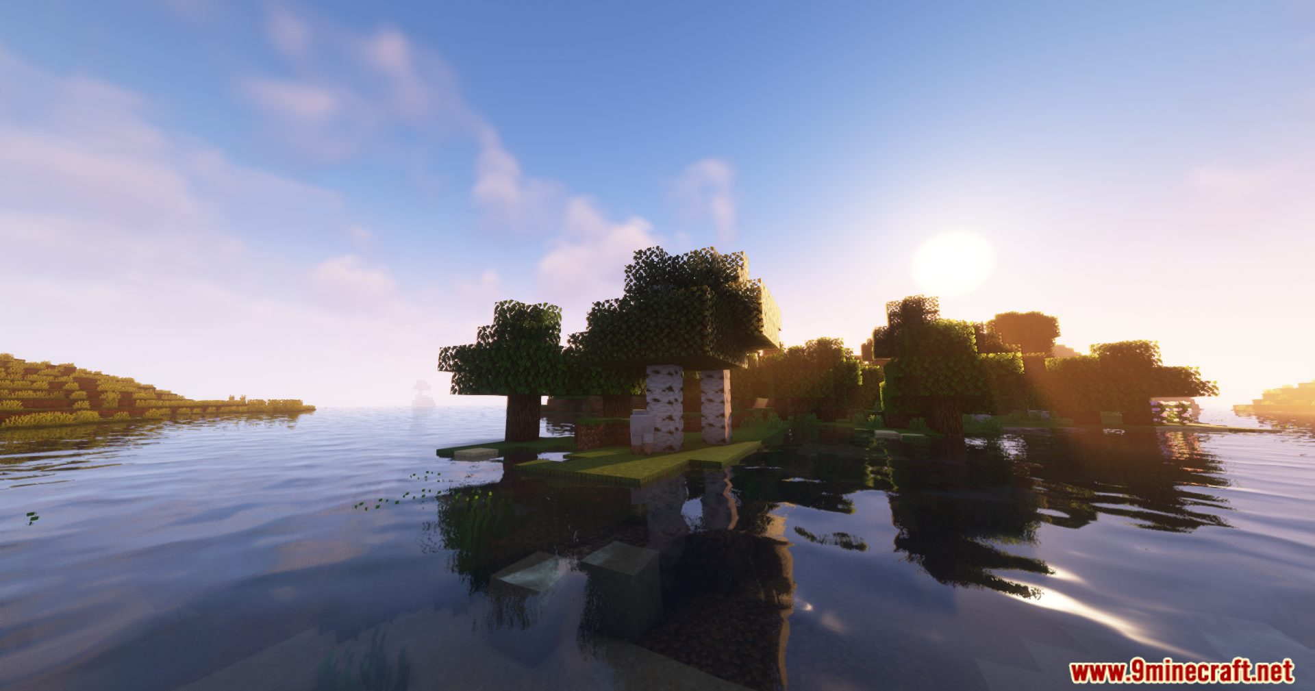A small island with trees sits in a calm body of water